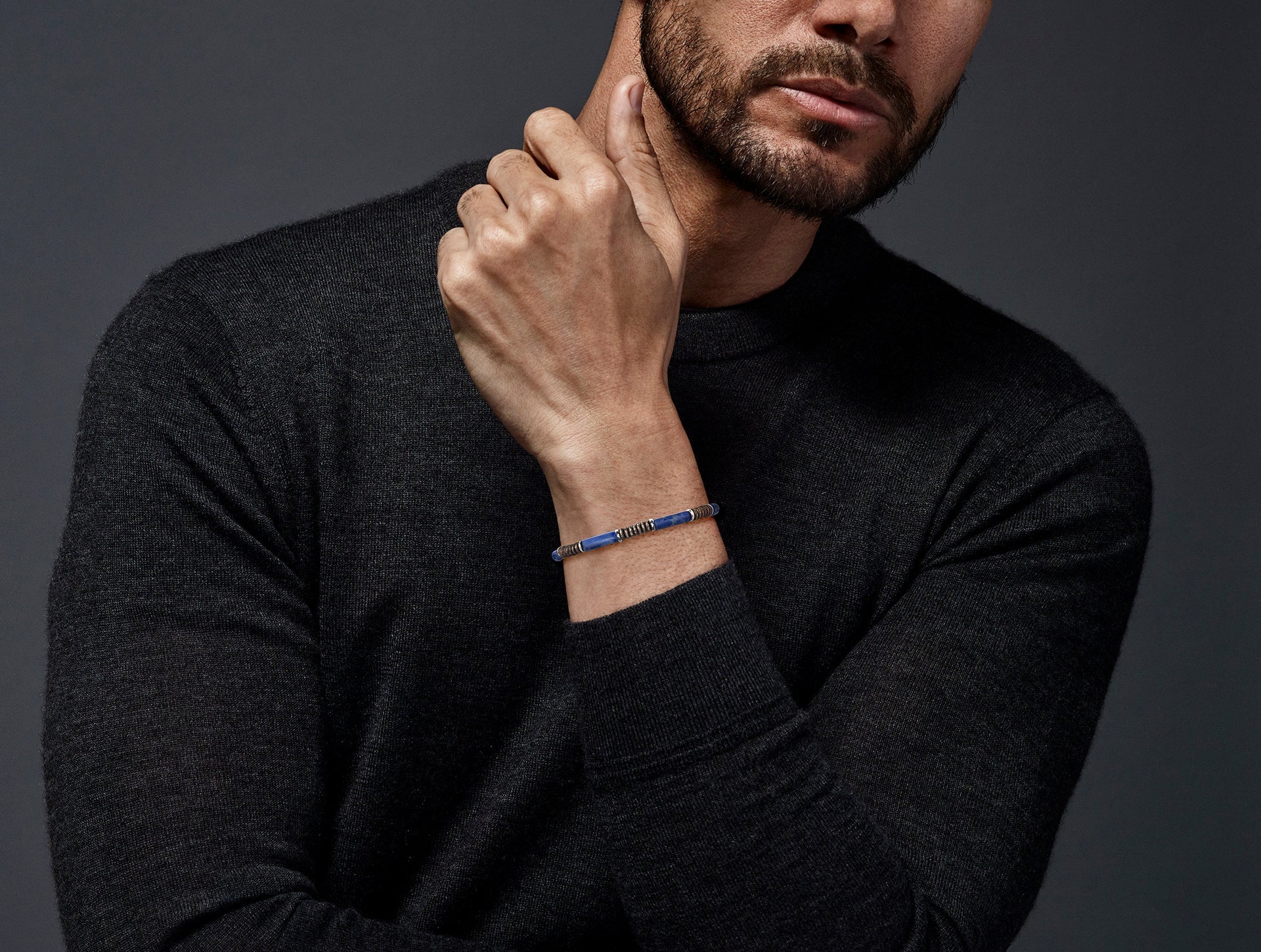 Royal blue lapis lazuli cylinder and oxidized sterling silver disc rondelle stretch bracelet worn on wrist