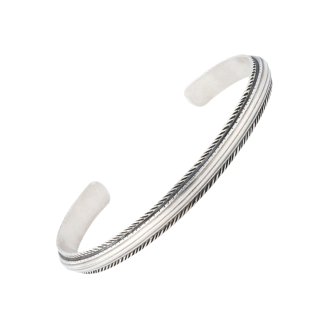 Sterling silver oxidized rope-edge triple-channel open cuff bracelet three-quarter view showing full cuff silhouette and oxidized rope border detail by Jan Leslie