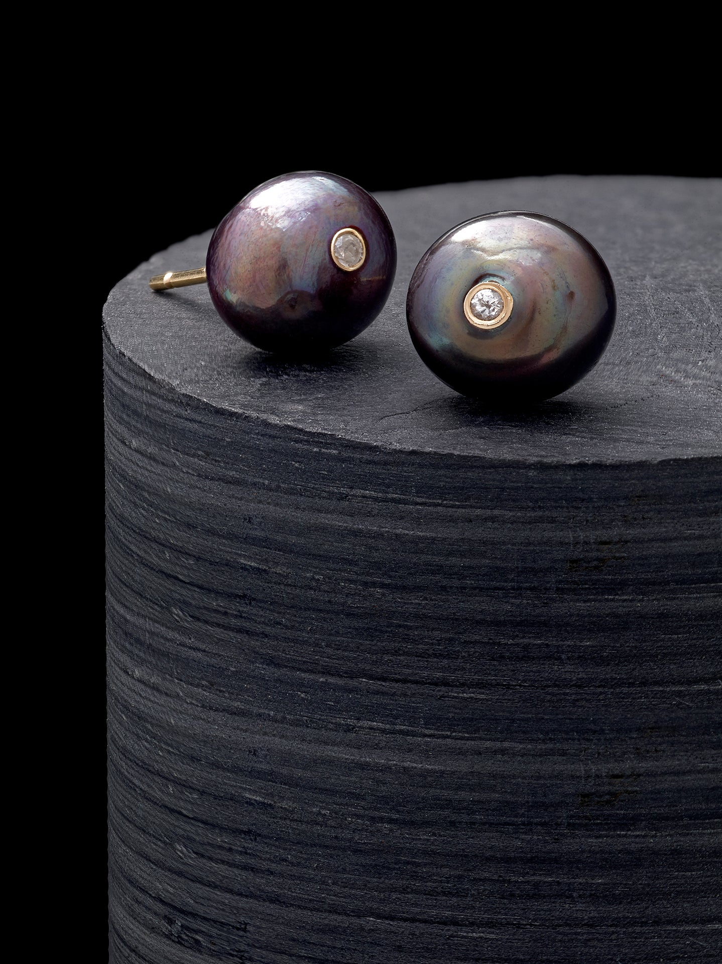 Tahitian black pearl stud earrings with bezel-set diamond accent on 14K gold post. Jan Leslie
