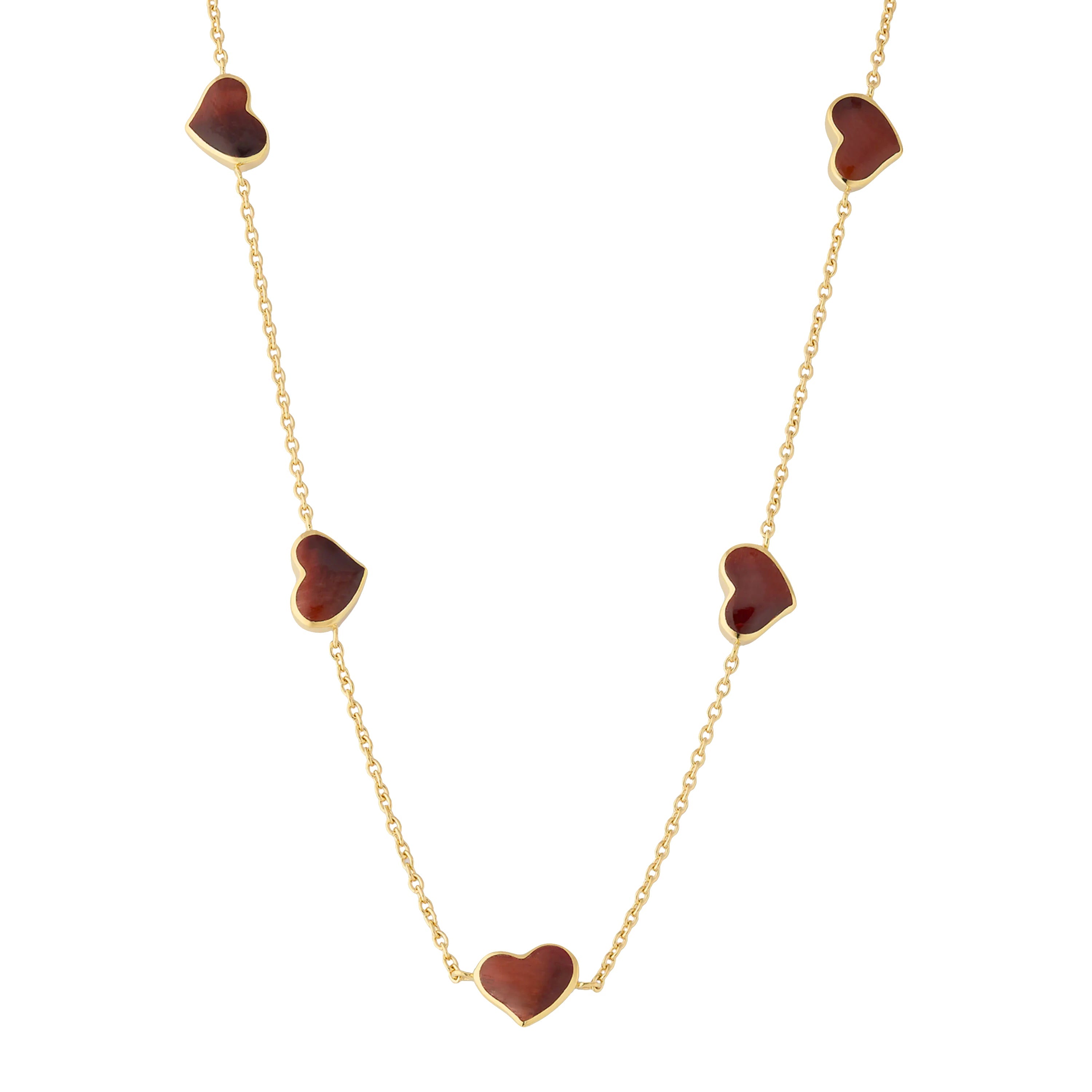 "Red tiger's eye five-heart station necklace draped on gold cable chain — Jan Leslie