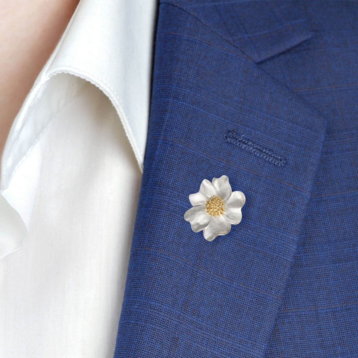 Sterling silver brushed daisy flower lapel pin with a gold granulated center — a charming, nature-inspired accessory to brighten any suit or blazer.
