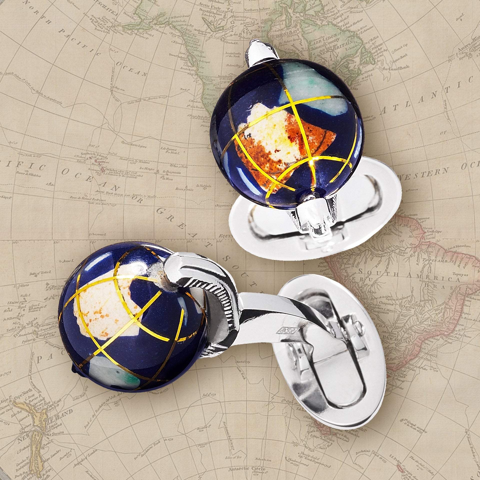 Spinning Lapis Globe with Semi-Precious Stone Inlay Sterling Silver Cufflinks on a map background.