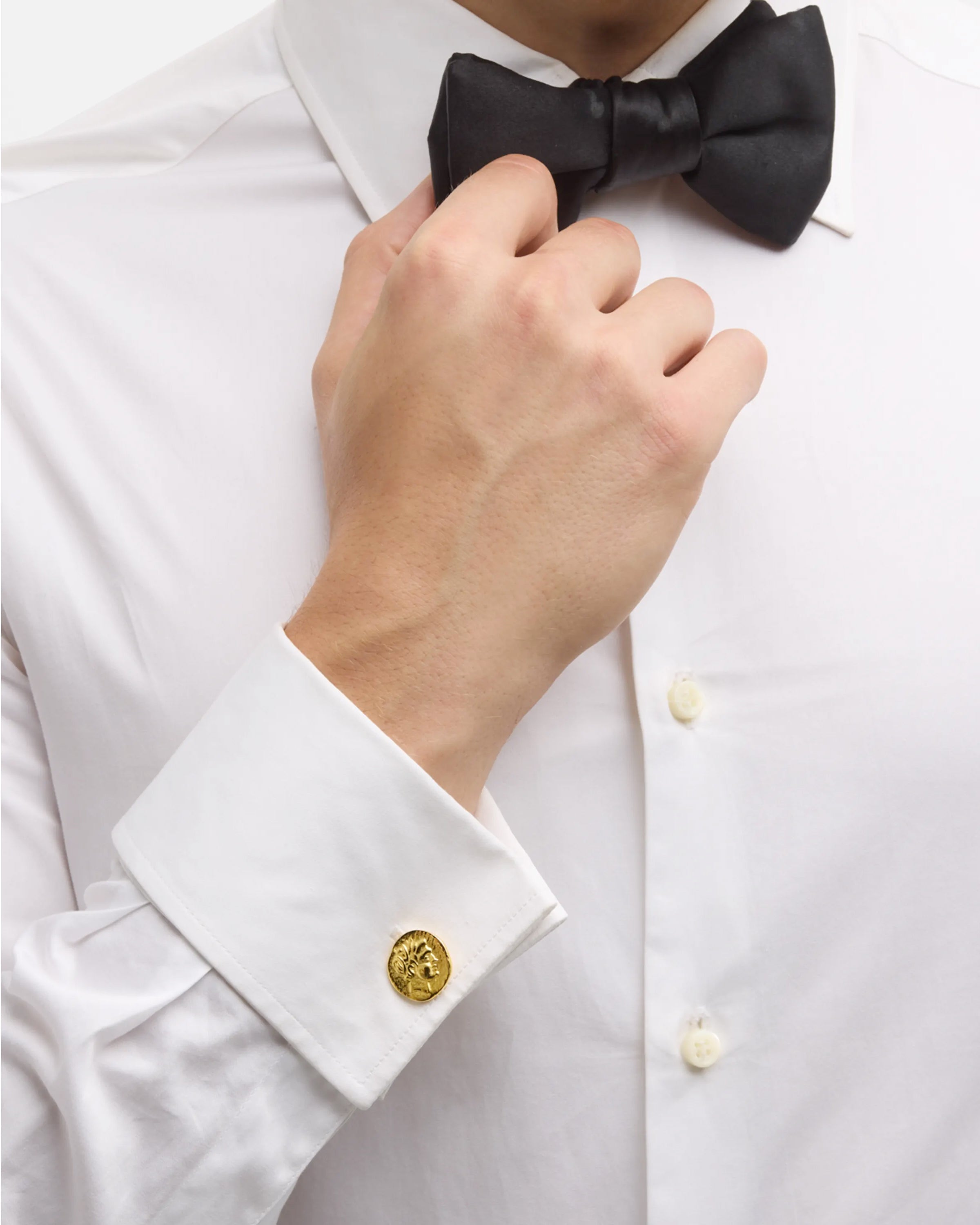 Men's gold ancient coin cufflinks styled on white tuxedo shirt with black bow tie, Jan Leslie