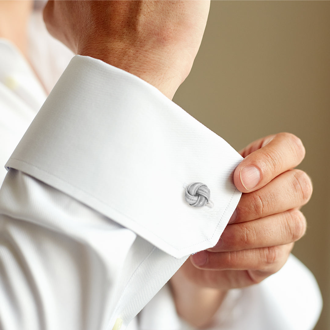 The sterling silver ribbed rope knot cufflink worn on a French cuff.