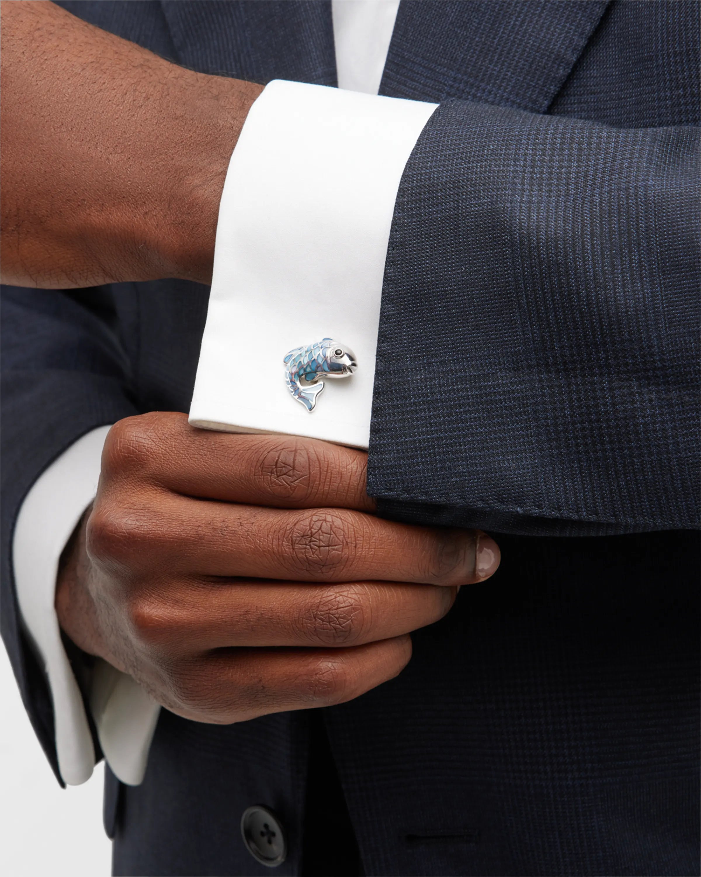 Male model wearing Jan Leslie's Koi Fish with Mother of Pearl & Sterling Silver Cufflinks with blue mother of pearl inlay on a white cuffed shirt and grey sports coat.