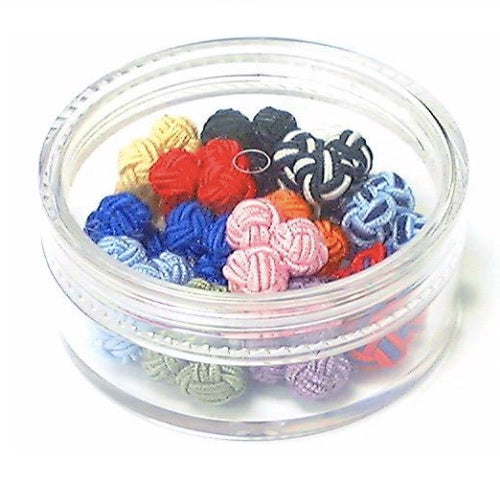 Assorted colorful knot cufflinks in clear container.