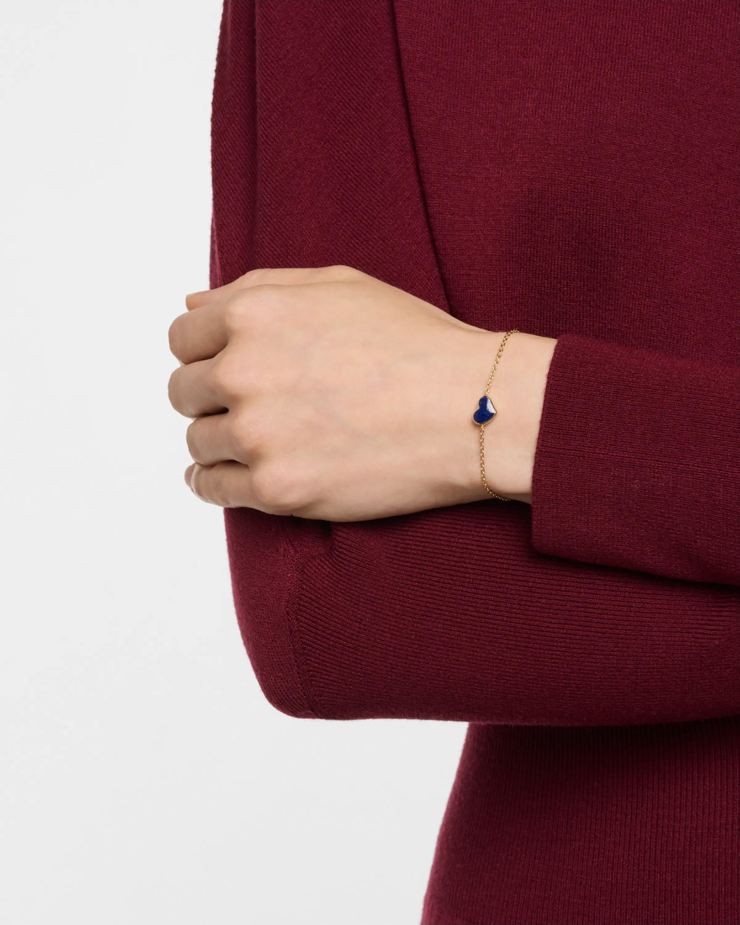 Model wearing blue lapis heart station bracelet on gold cable chain — Jan Leslie"