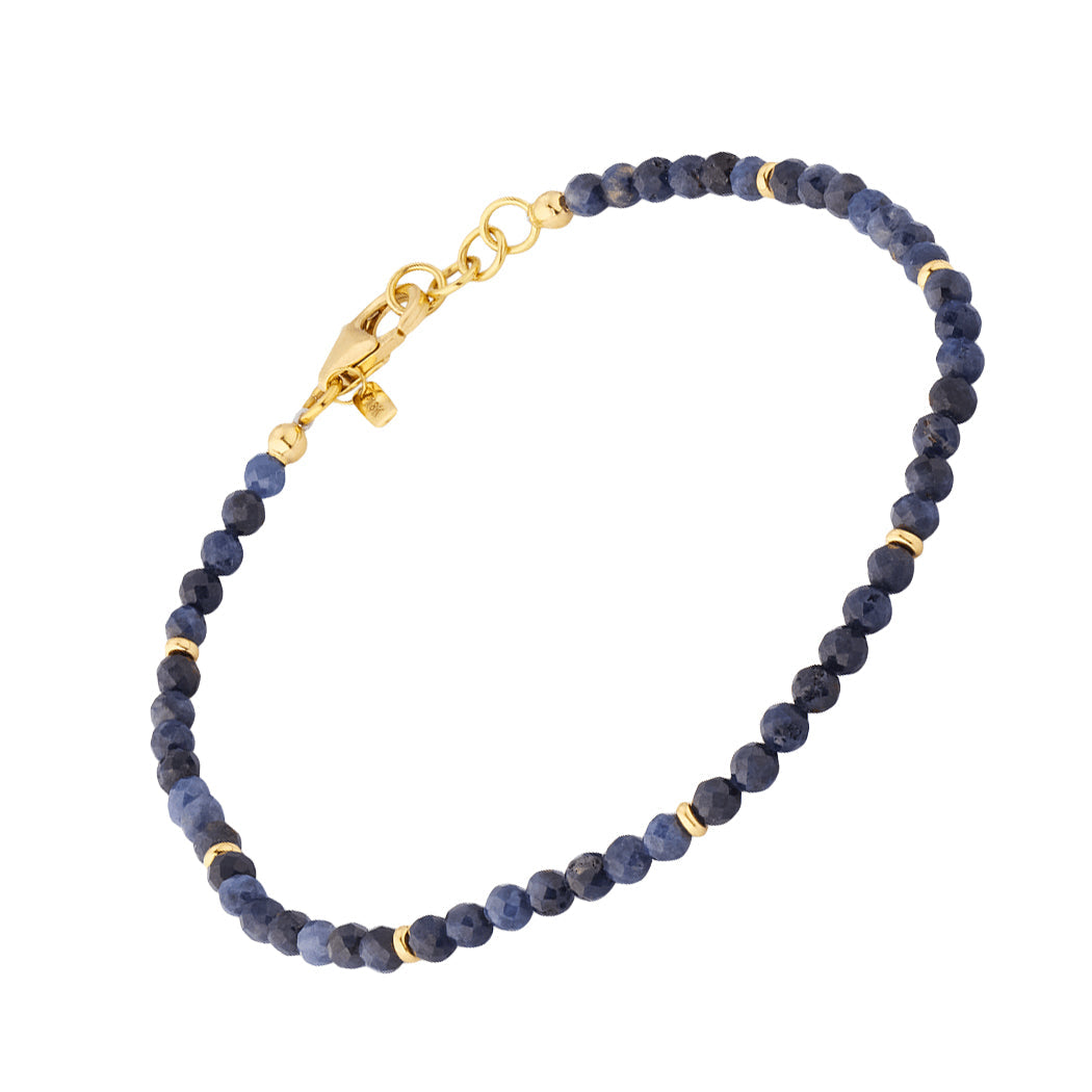 Blue sapphire faceted round bead bracelet full silhouette showing deep midnight blue sapphire beads gold vermeil spacers and gold vermeil lobster clasp with extender chain by Jan Leslie