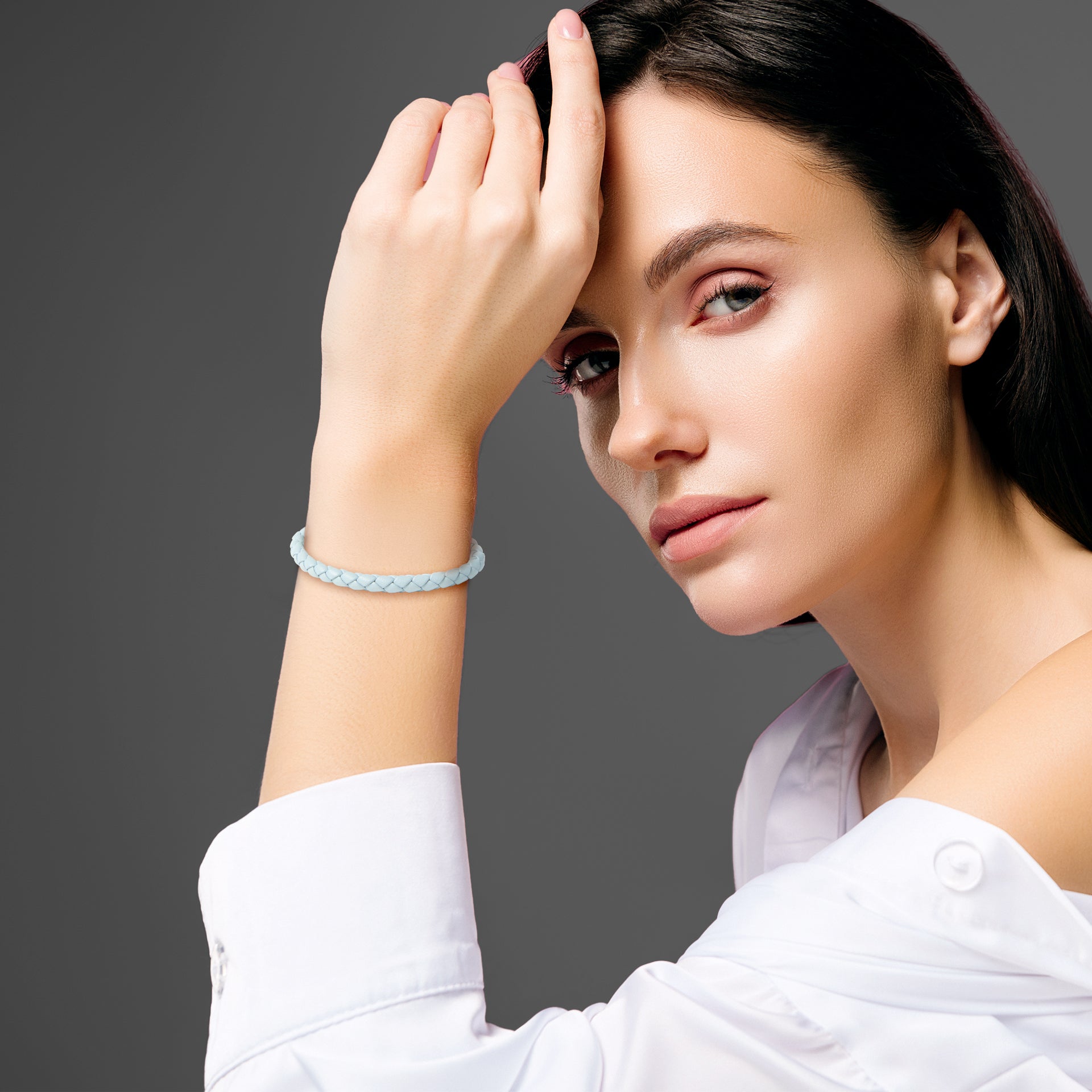 Model wearing sky blue braided leather bracelet with gold magnetic clasp on wrist  by Jan Leslie