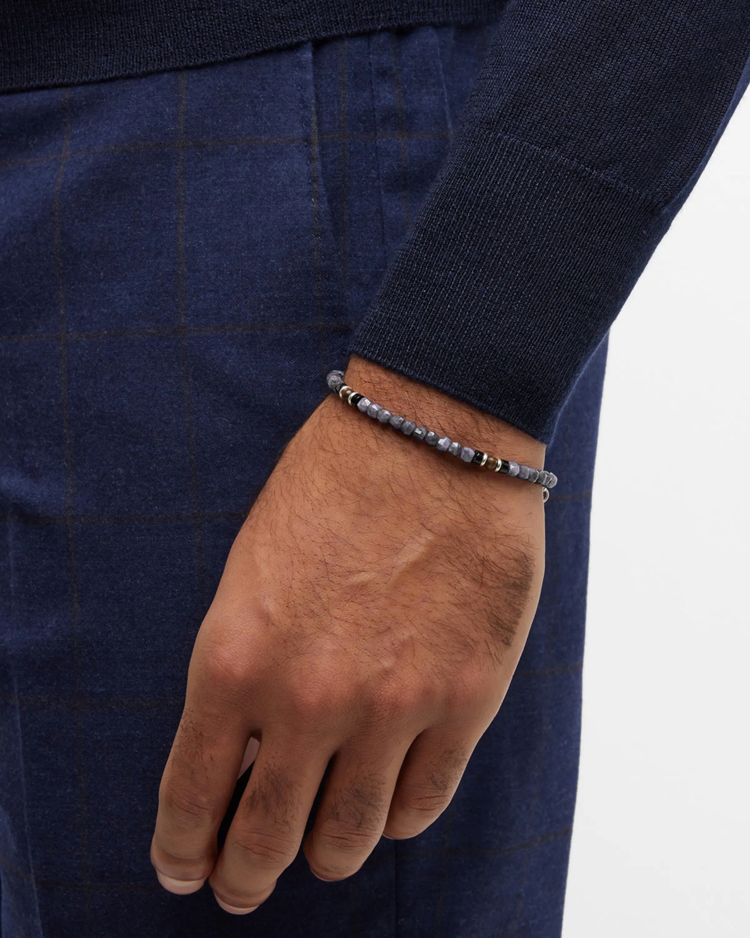 Grey labradorite and black onyx micro-bead stretch bracelet with gold vermeil rondelle spacers, worn with navy knitwear