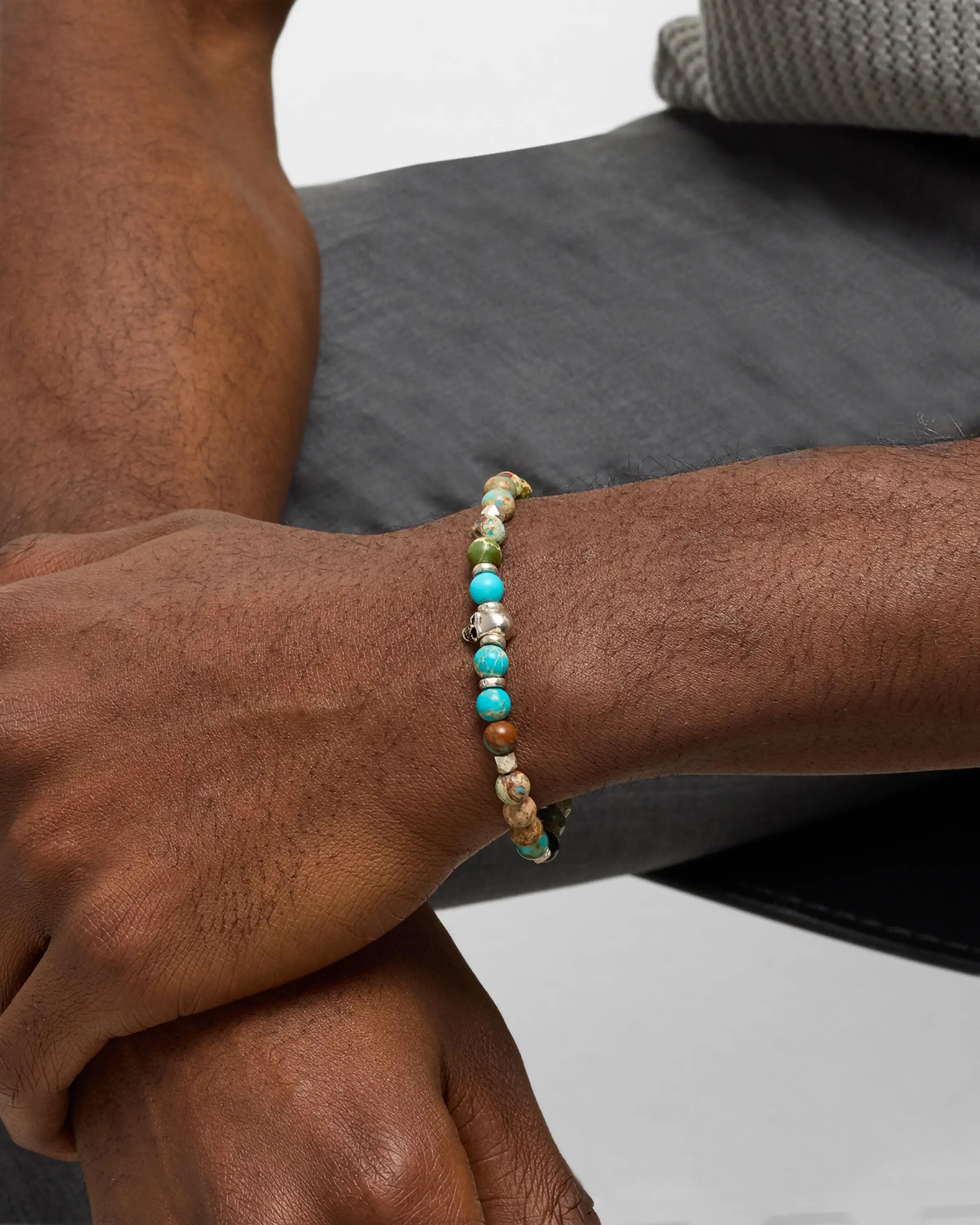 Turquoise and imperial jasper stretch bracelet with sterling silver skull centerpiece