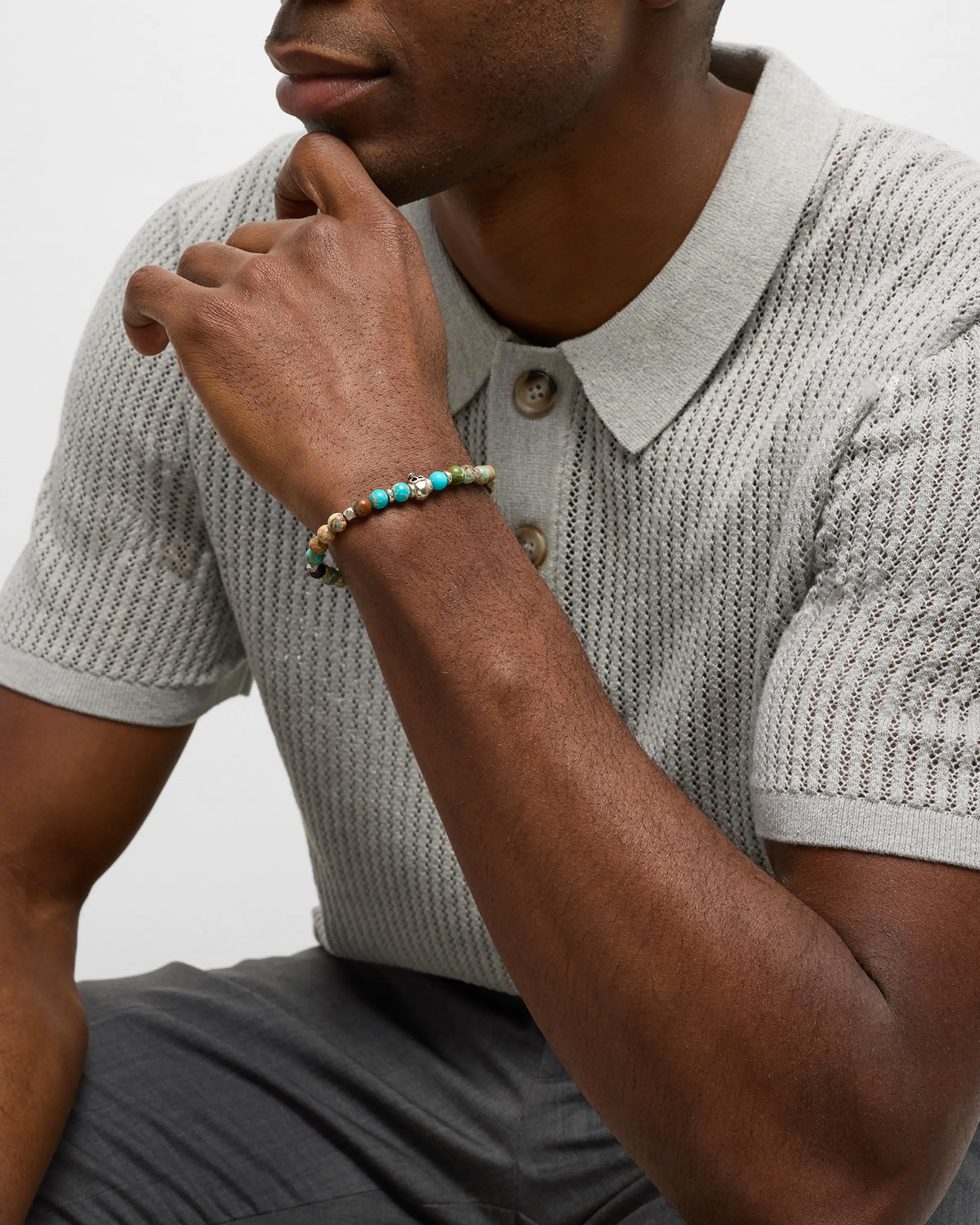 Men's turquoise and imperial jasper stretch bracelet with sterling silver skull centerpiece.