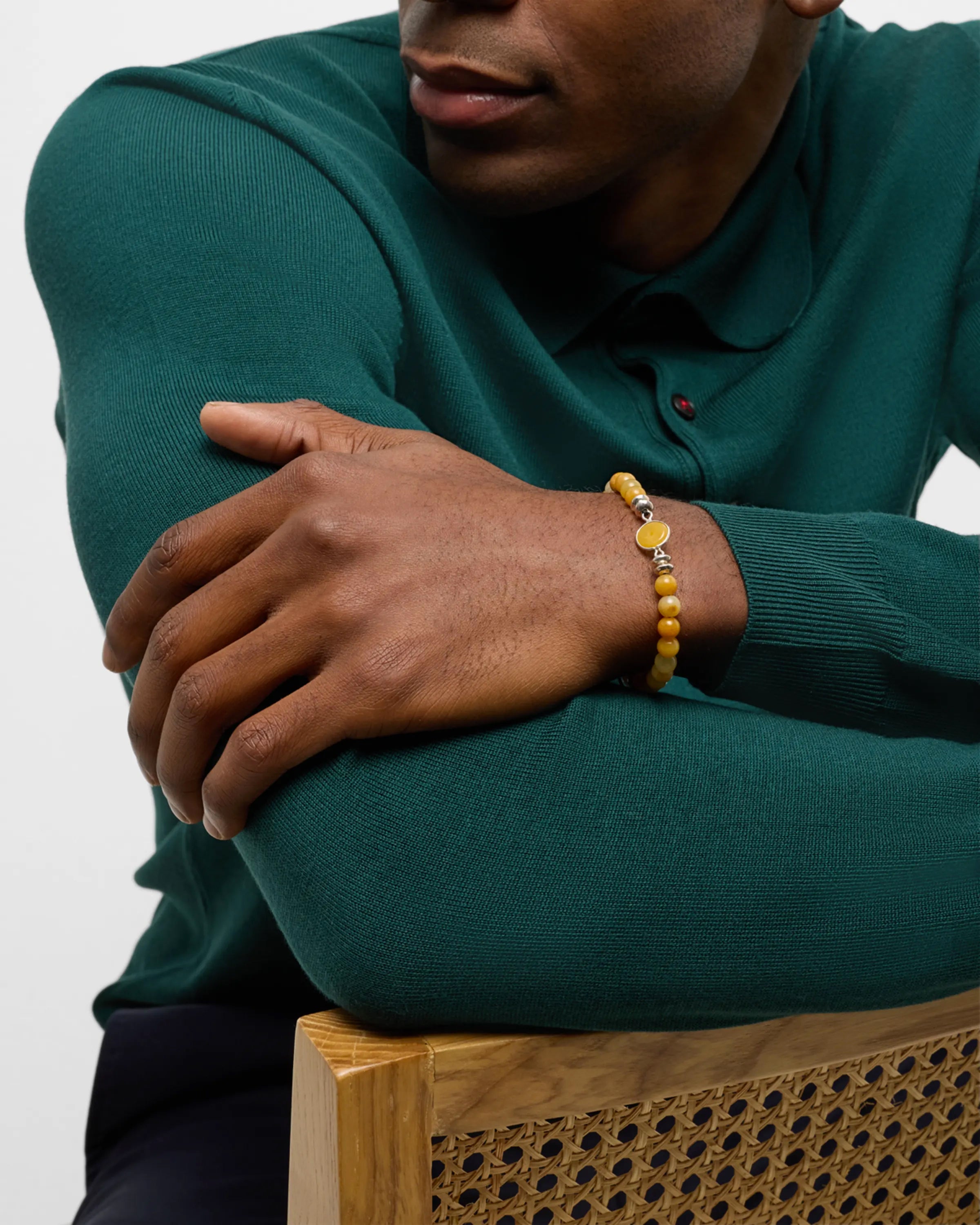 Men's yellow agate bead bracelet with sterling silver oval bezel centerpiece styled with navy suit and teal knit sweater, Jan Leslie
