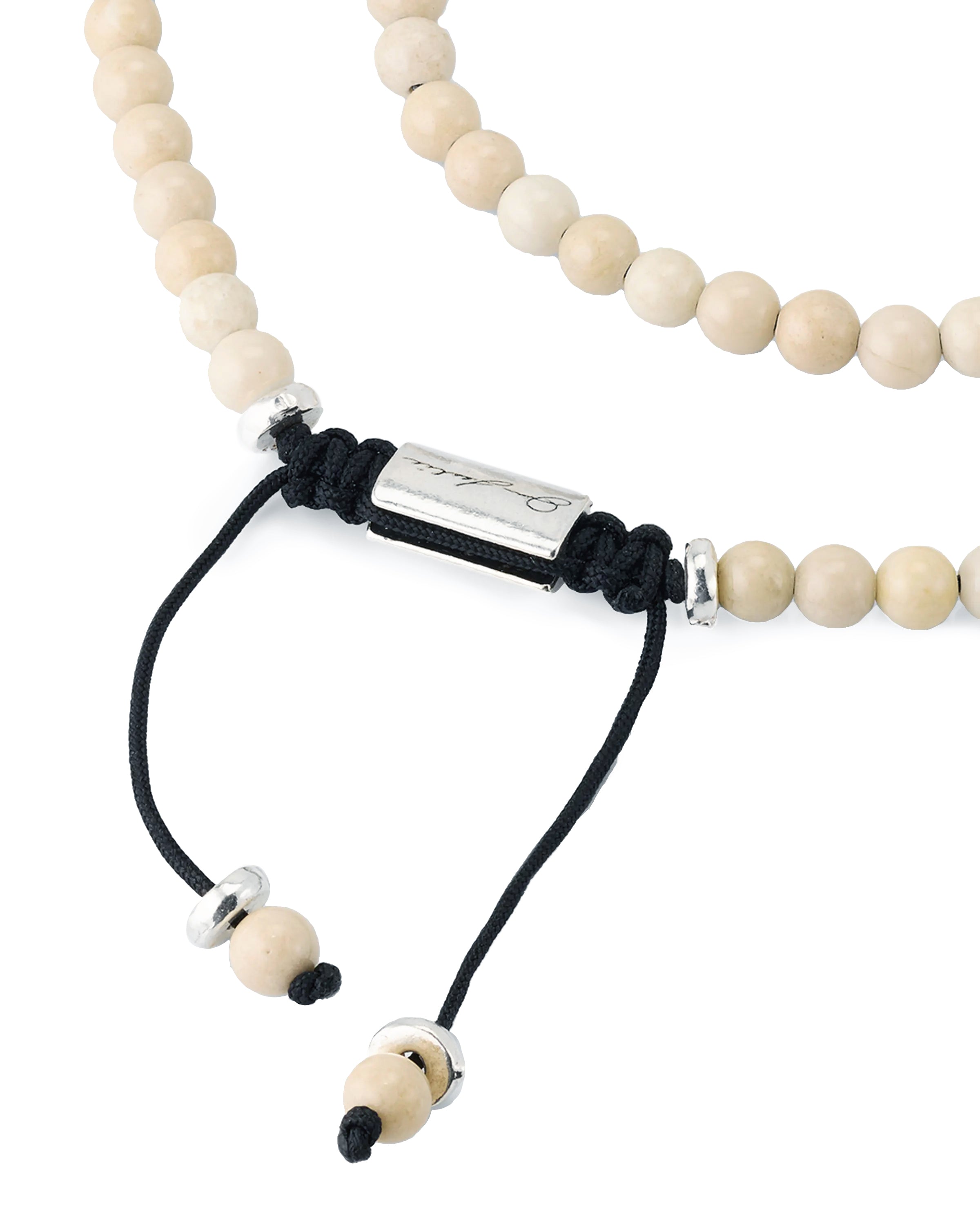 Men's natural riverstone double-wrap bracelet with sterling silver spacers, lava stone accent, and Jan Leslie