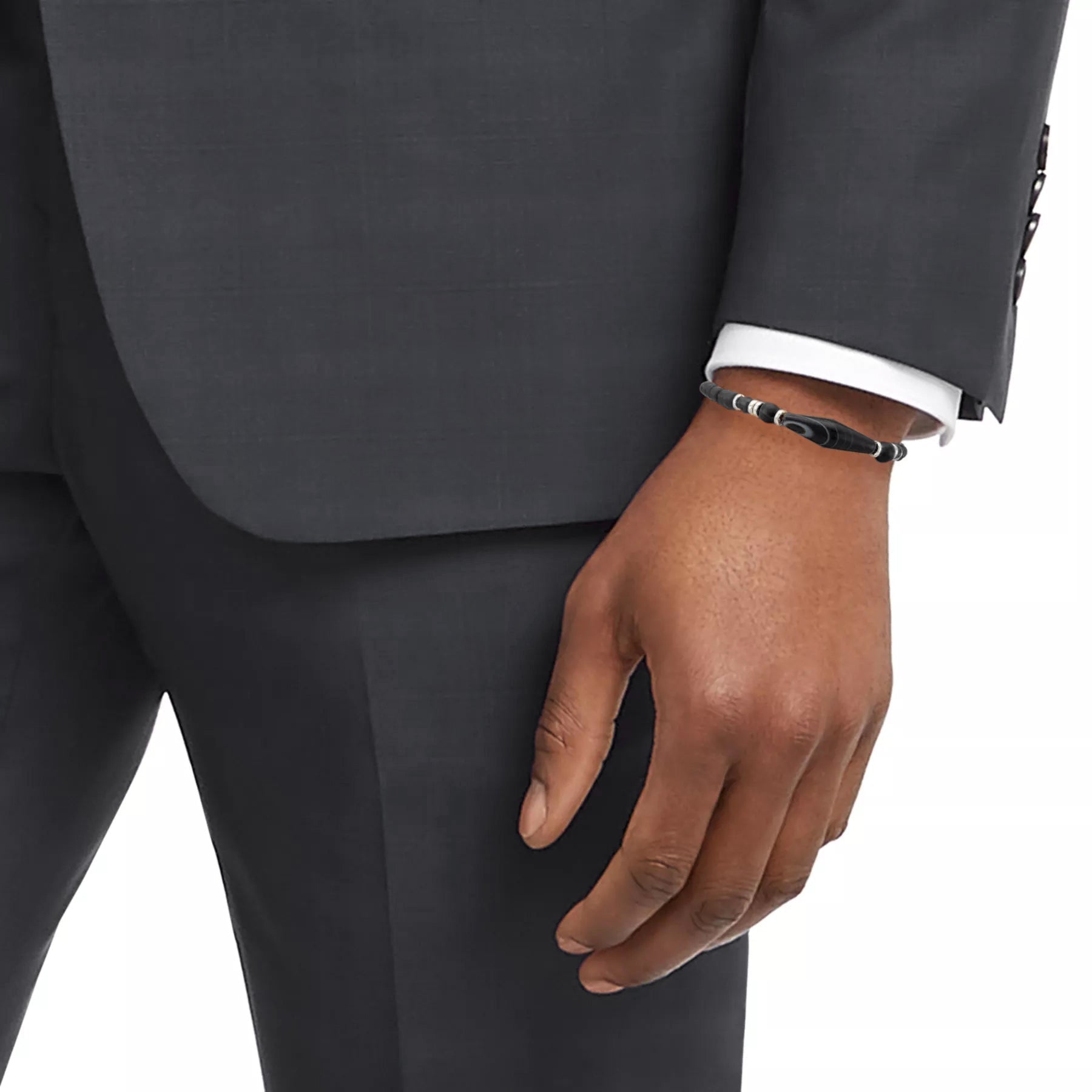 Men's black onyx bead bracelet with Tibetan dzi agate centerpiece styled with charcoal suit and white dress shirt, Jan Leslie