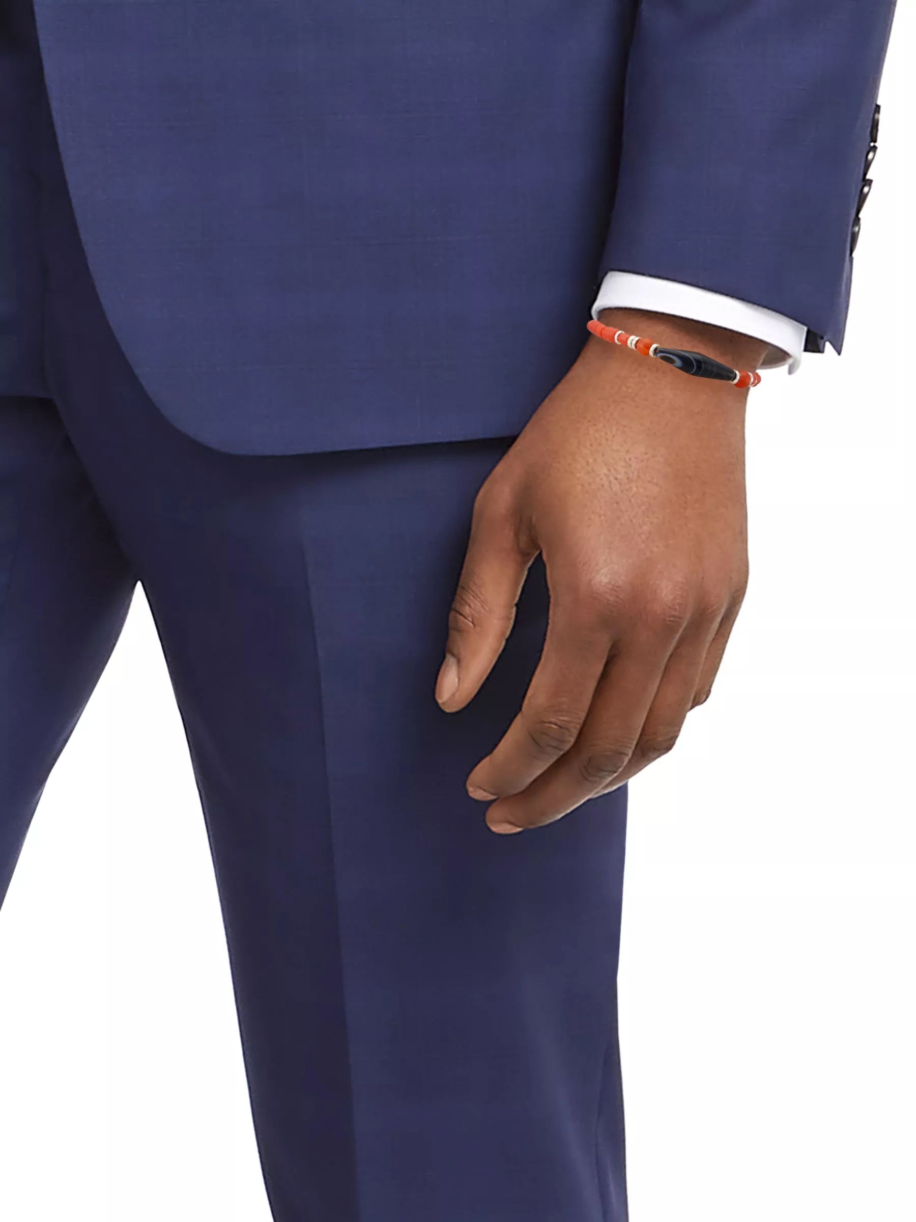 Men's coral red glass bead bracelet with Tibetan dzi agate charm styled with navy suit and white dress shirt, Jan Leslie
