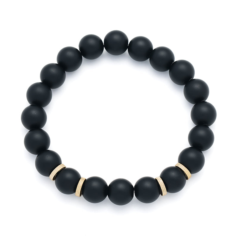 Matte black onyx round bead stretch bracelet with gold textured ring spacers.