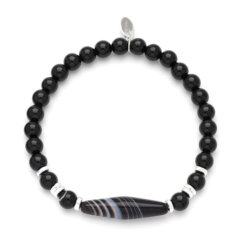 Matte black glass tube bead stretch bracelet with Tibetan dzi agate centerpiece and sterling silver rondelle spacers, Jan Leslie