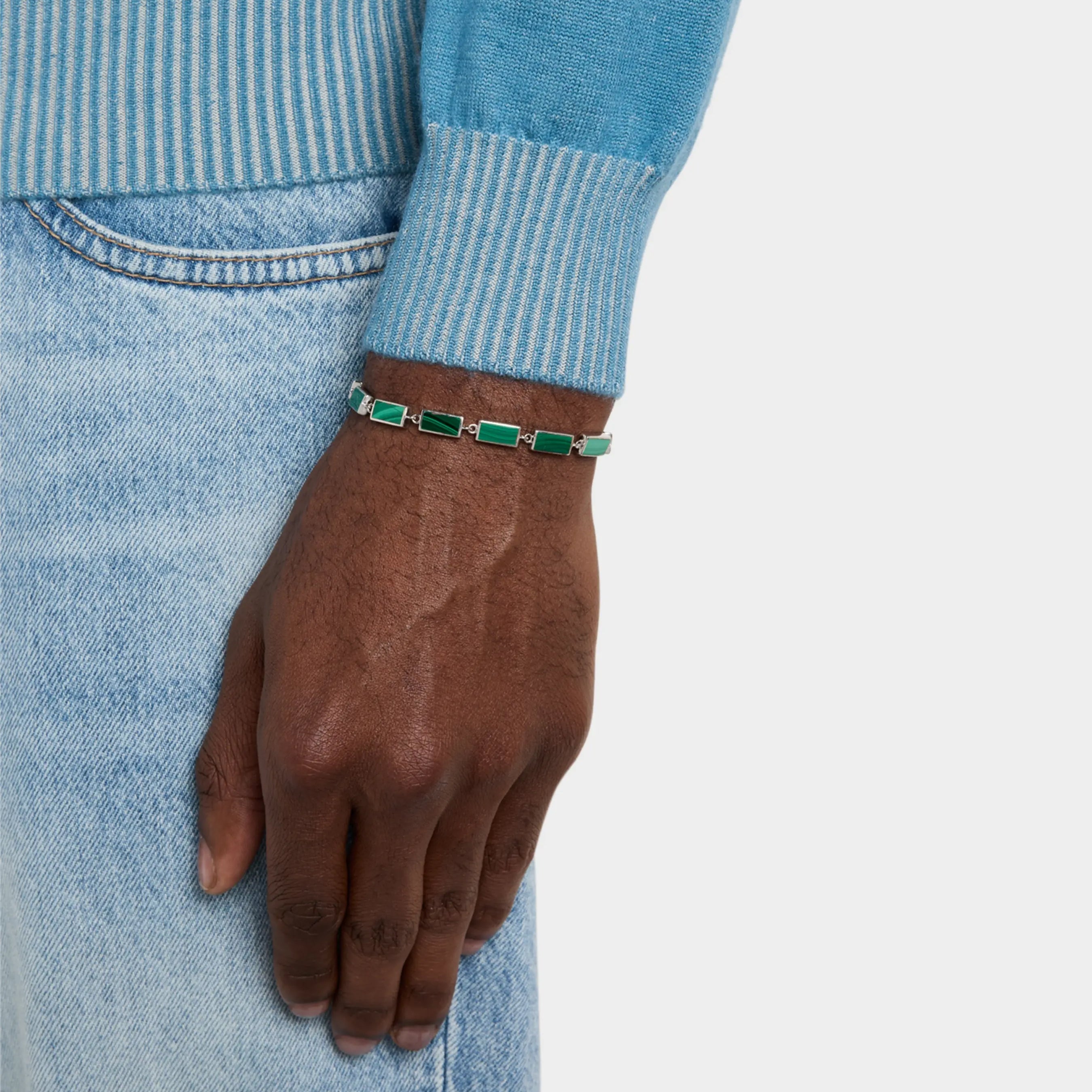  Man wearing sterling silver malachite rectangular station tennis bracelet at wrist showing continuous deep forest green malachite stone face with vivid emerald banding by Jan Leslie