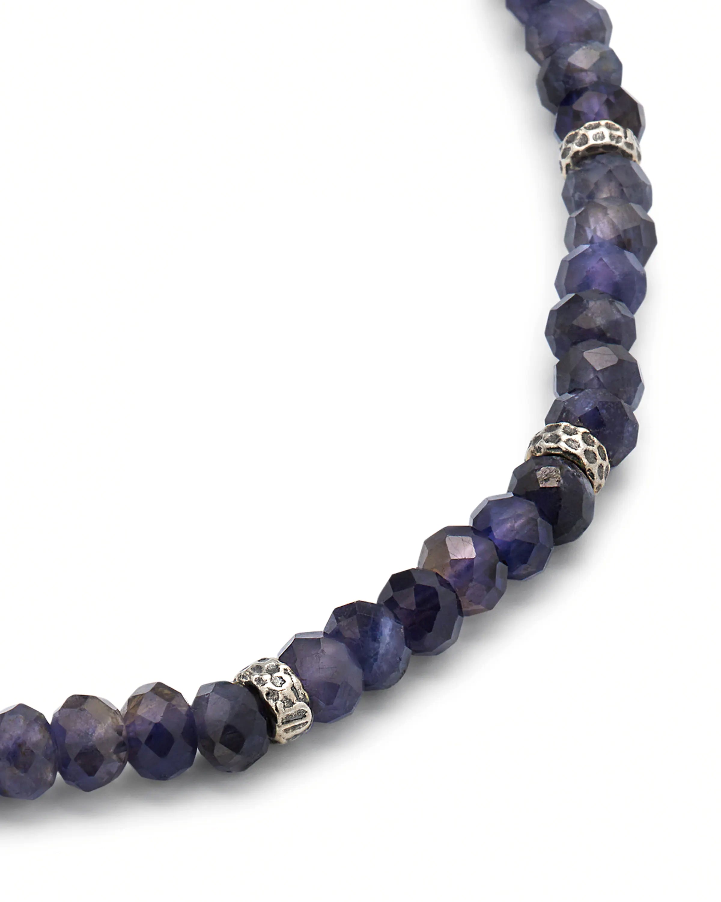  Blue iolite faceted rondelle bead bracelet close-up showing indigo blue iolite rondelle bead facets and oxidized sterling silver pavé spacer texture by Jan Leslie