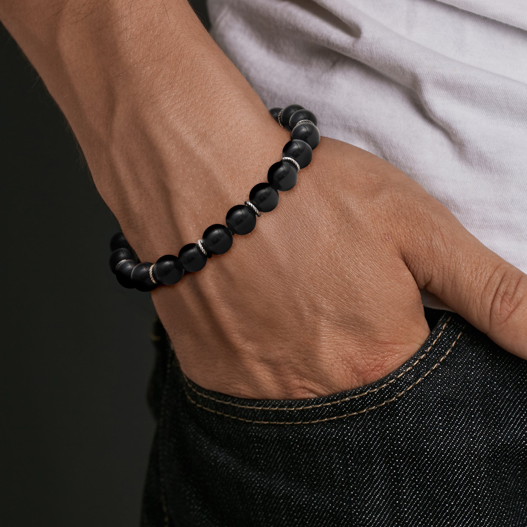 a matte black onyx beaded bracelet with sterling silver rondelle accents.
