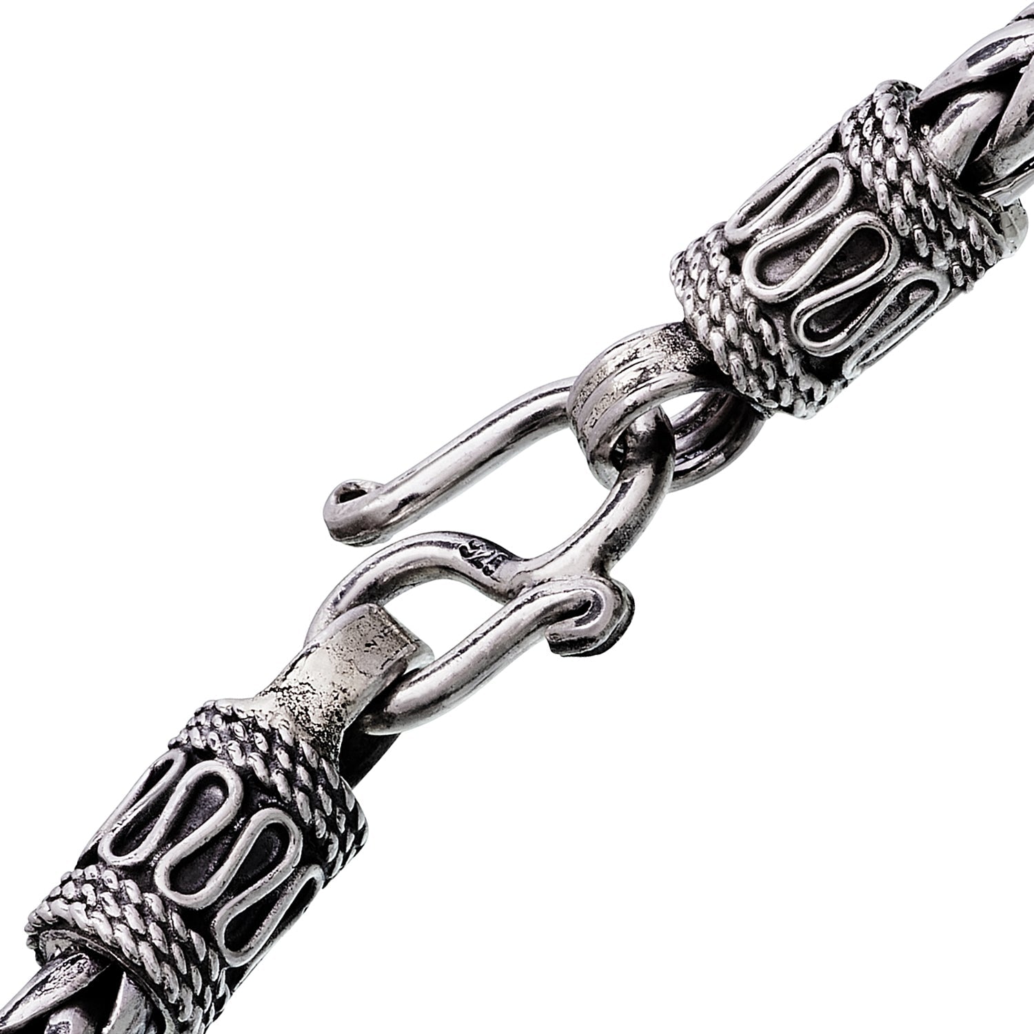 Close-up of oxidized sterling silver wide braided wheat chain bracelet showing rope-wrapped end caps and hook clasp with 925 hallmark by Jan Leslie.