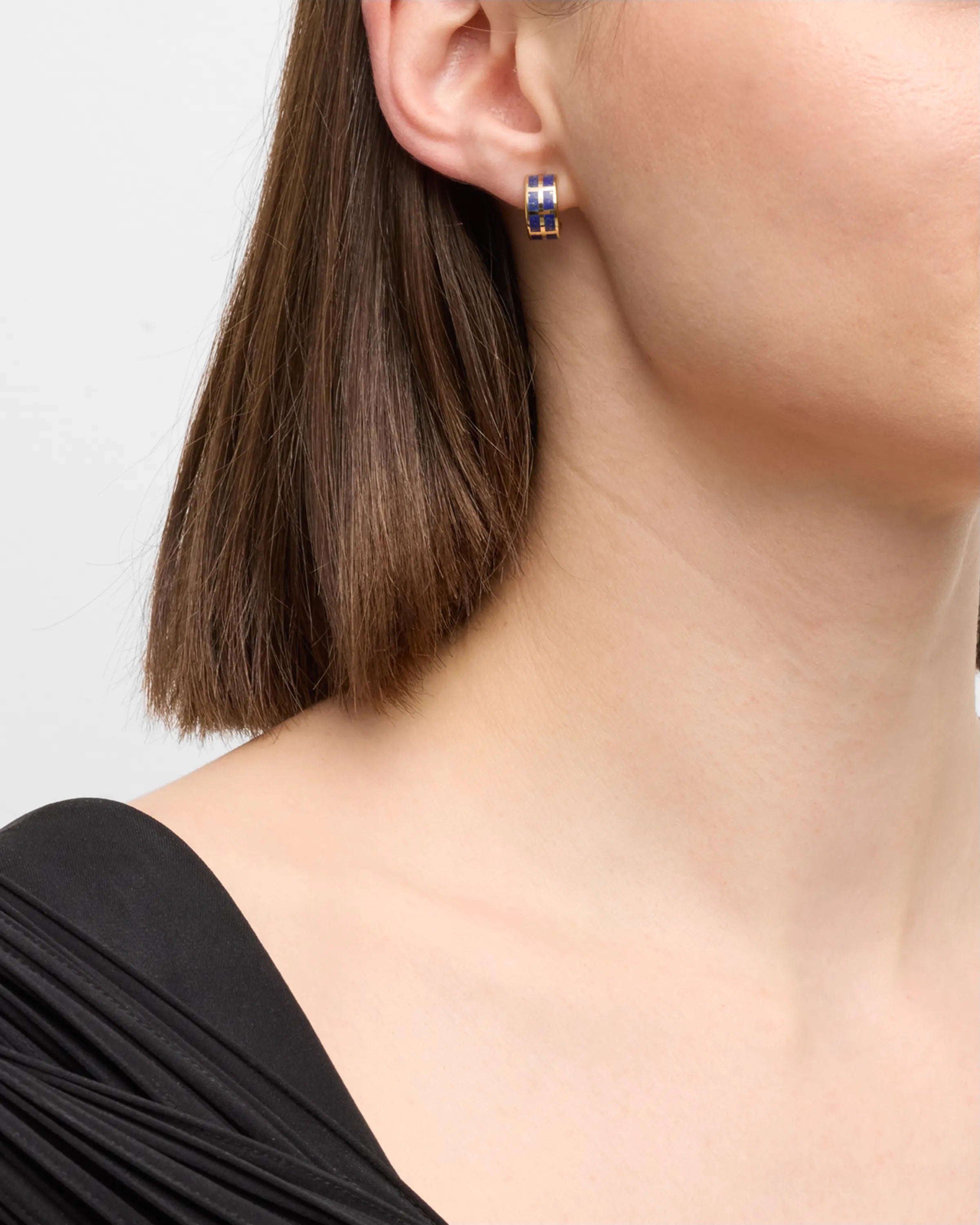 Model in black dress wearing stone tile inlay gold wide huggie hoop earring — Jan Leslie