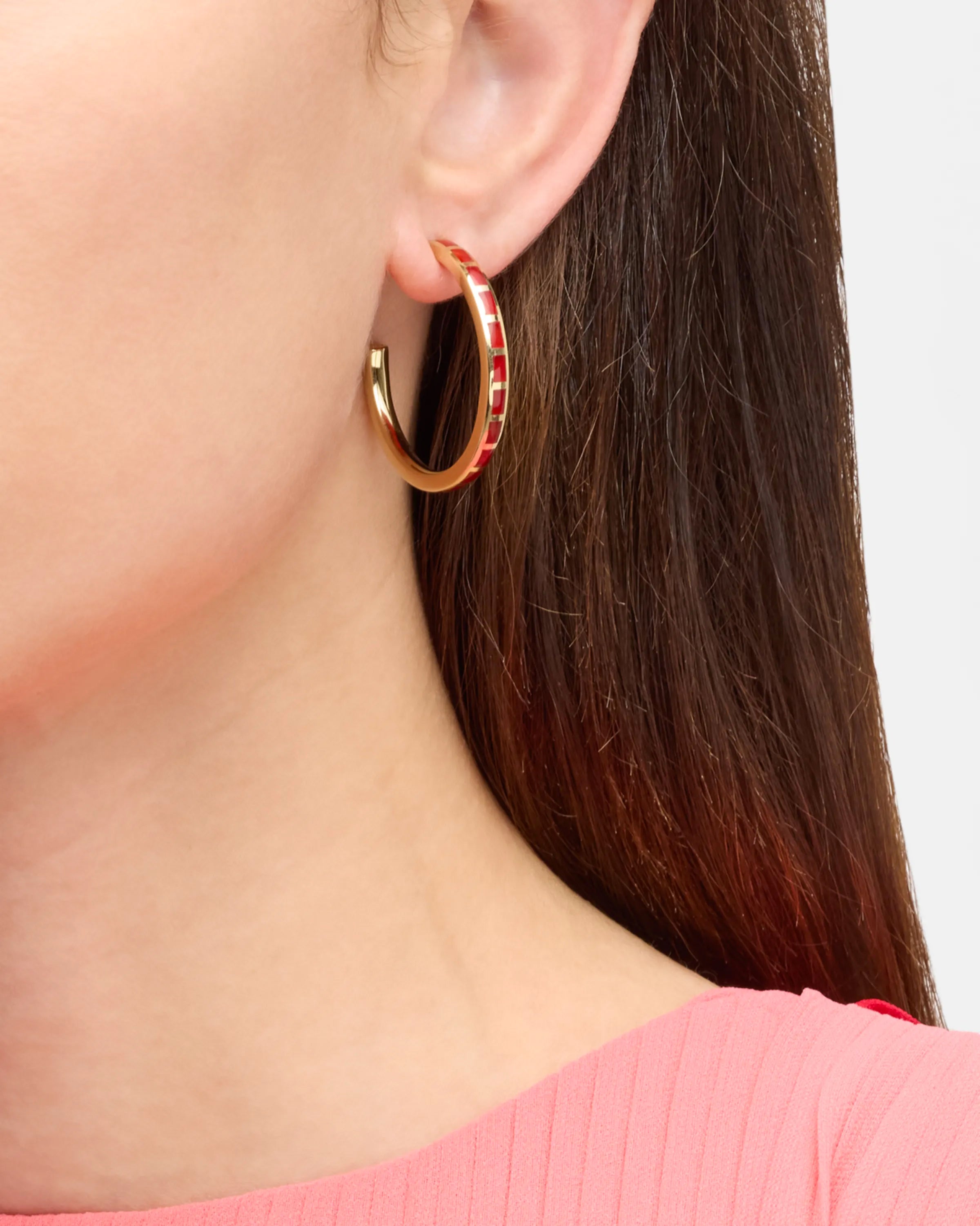 Model in wearing small gold hoop earrings with red coral enamel tile inlays — Jan Leslie