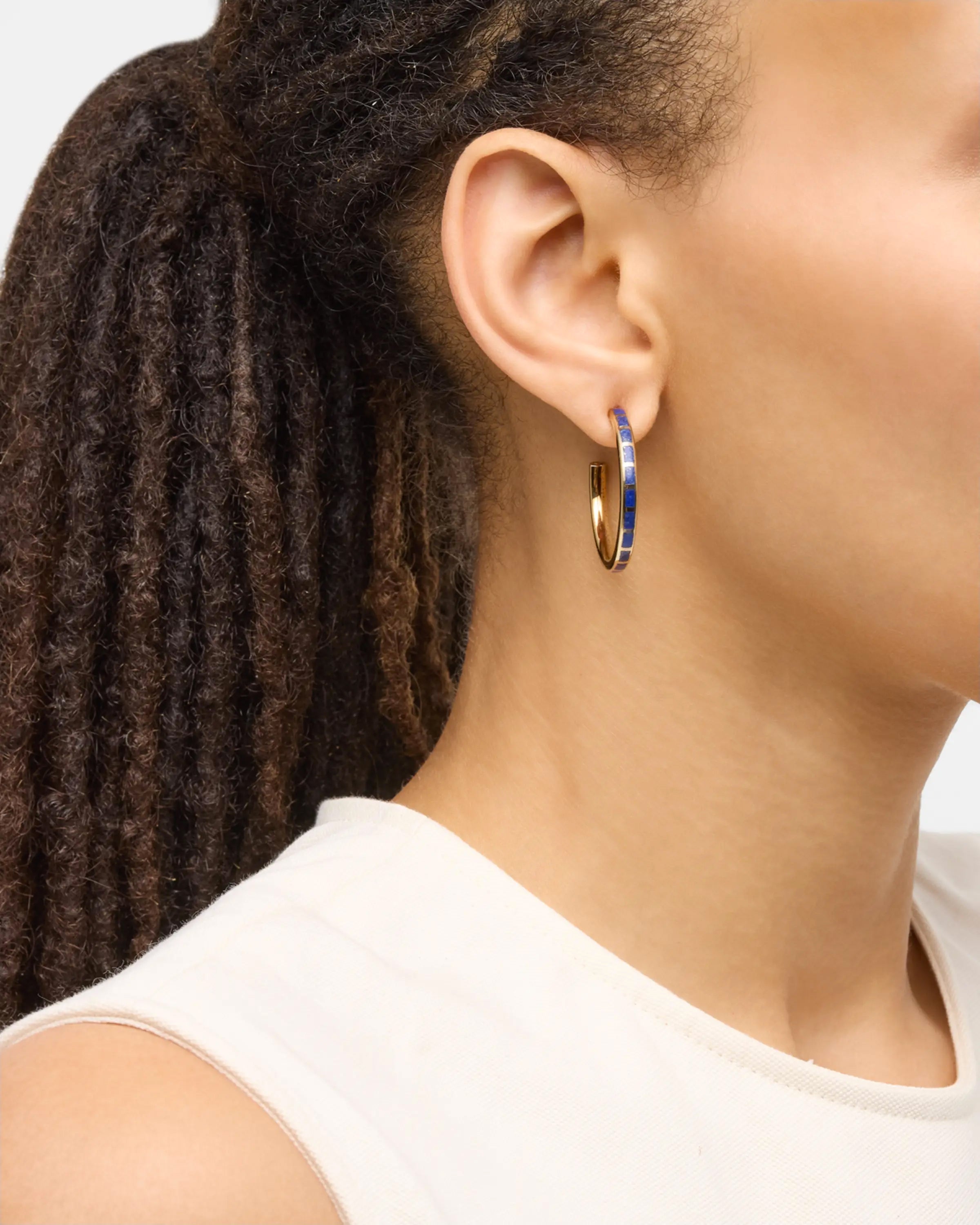 Model wearing small gold hoop earrings with blue lapis tile inlays — Jan Leslie