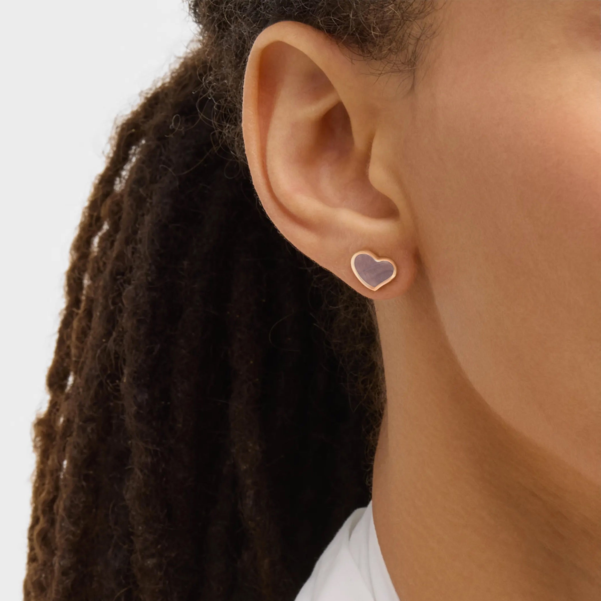 Rose gold vermeil grey mother of pearl heart stud earring close-up on ear with natural light, Jan Leslie luxury women's fine jewelry lifestyle.