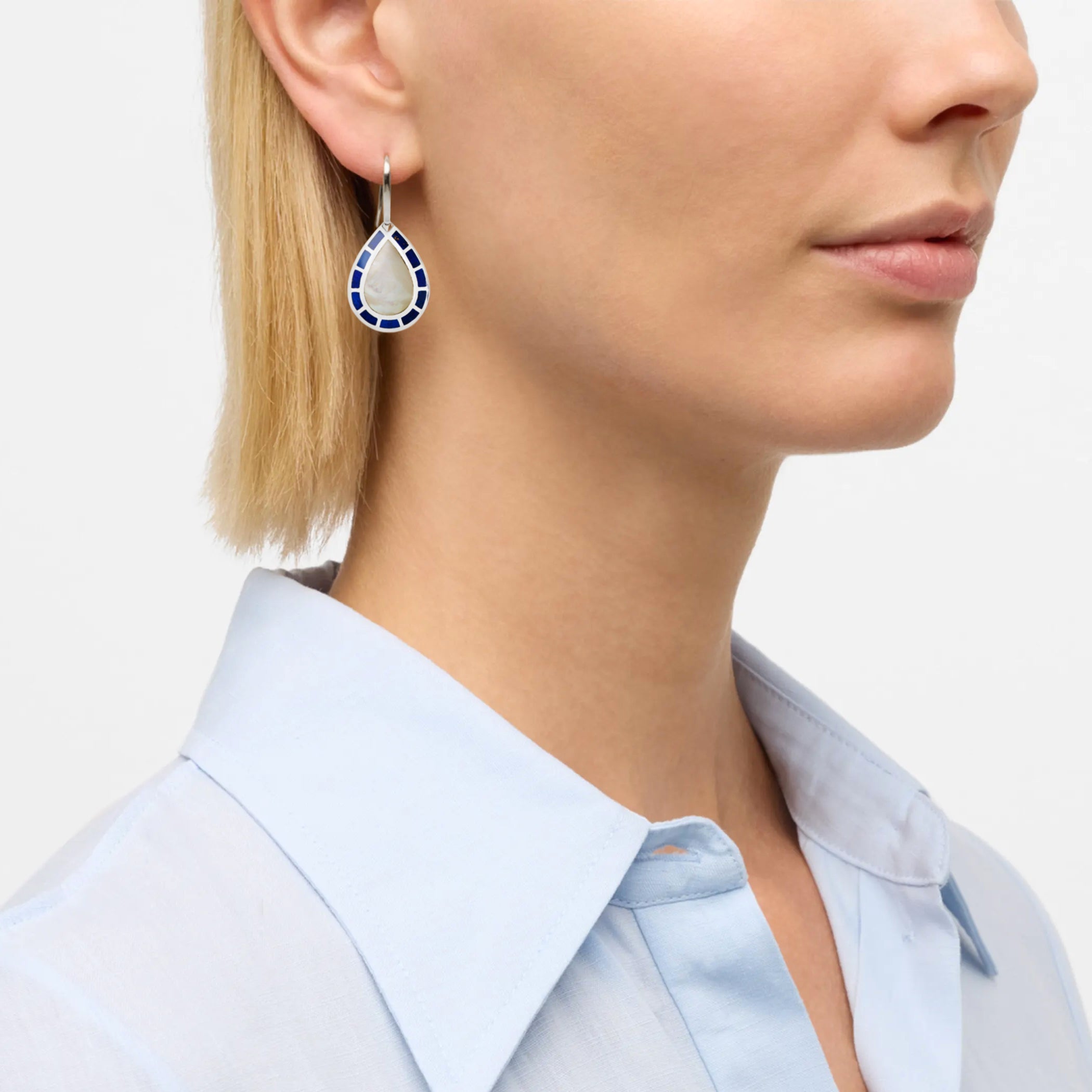 Model wearing sterling silver teardrop mother-of-pearl and cobalt blue enamel drop earrings by Jan Leslie.