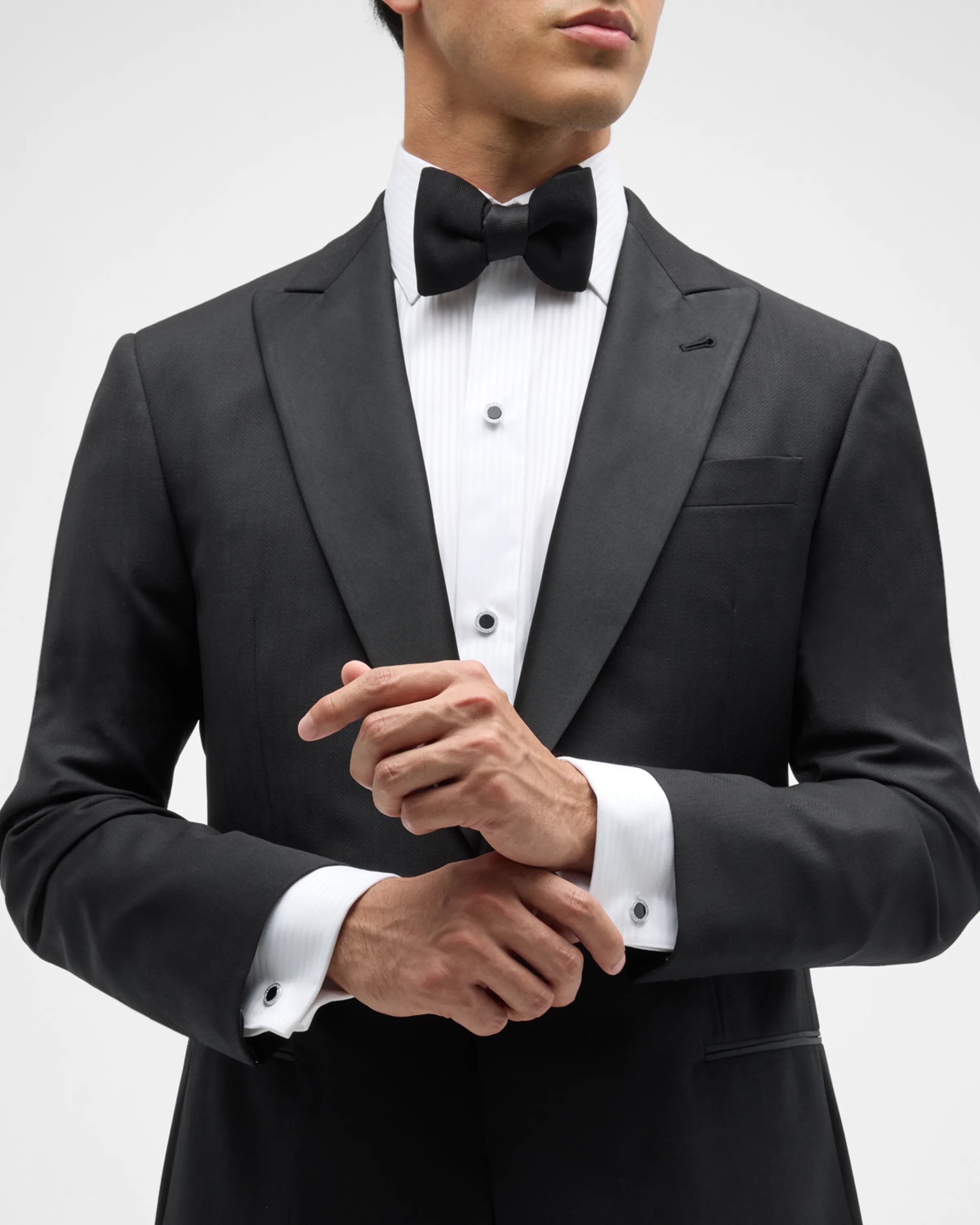  Man wearing sterling silver black onyx and crystal pavé tuxedo set close-up showing crystal pavé halo cufflinks at wrist with white French cuff and black tuxedo jacket by Jan Leslie