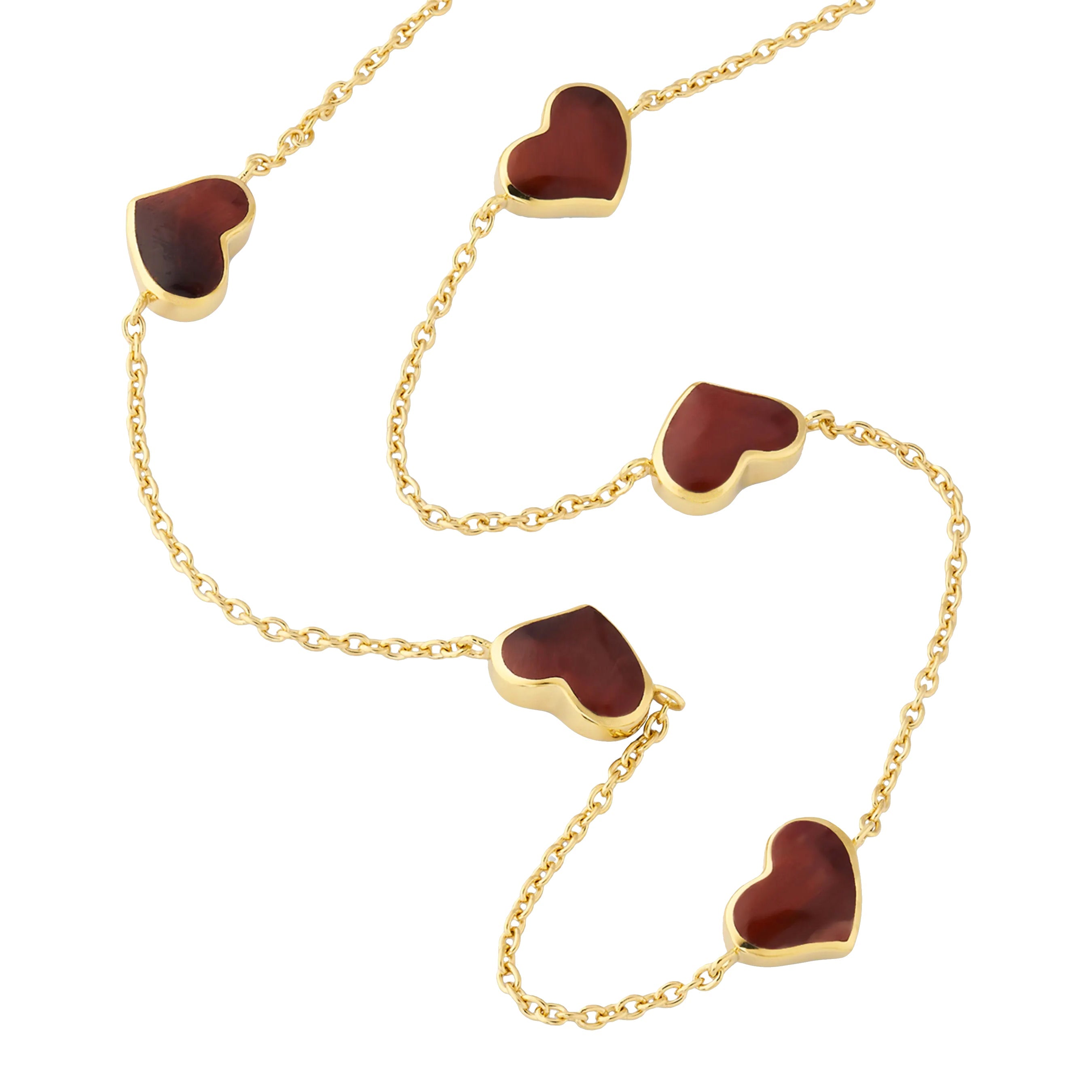 Red tiger's eye five-heart station necklace draped on gold cable chain — Jan Leslie