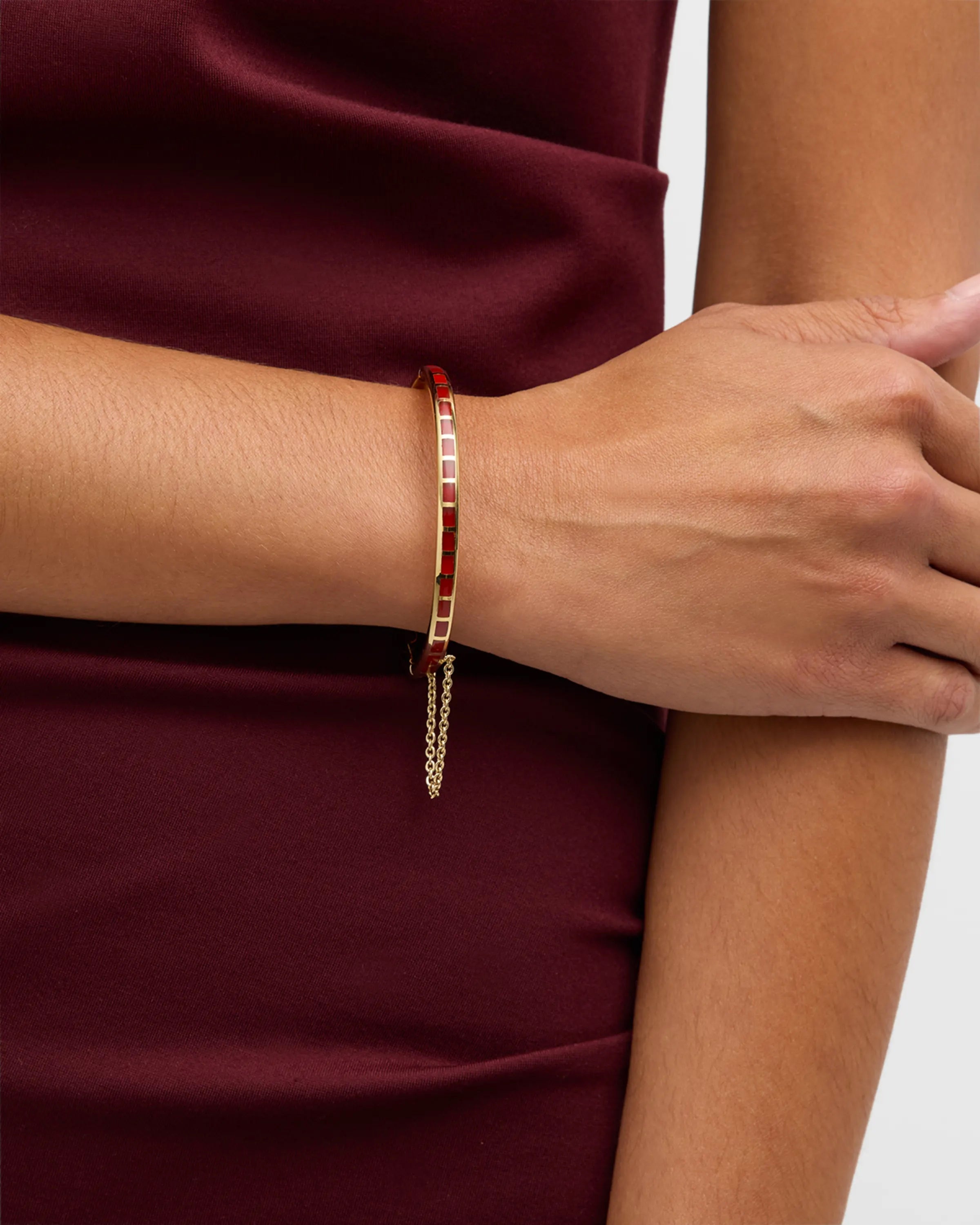 Channel-set coral red square tile gold vermeil open cuff bangle bracelet worn on model's wrist
