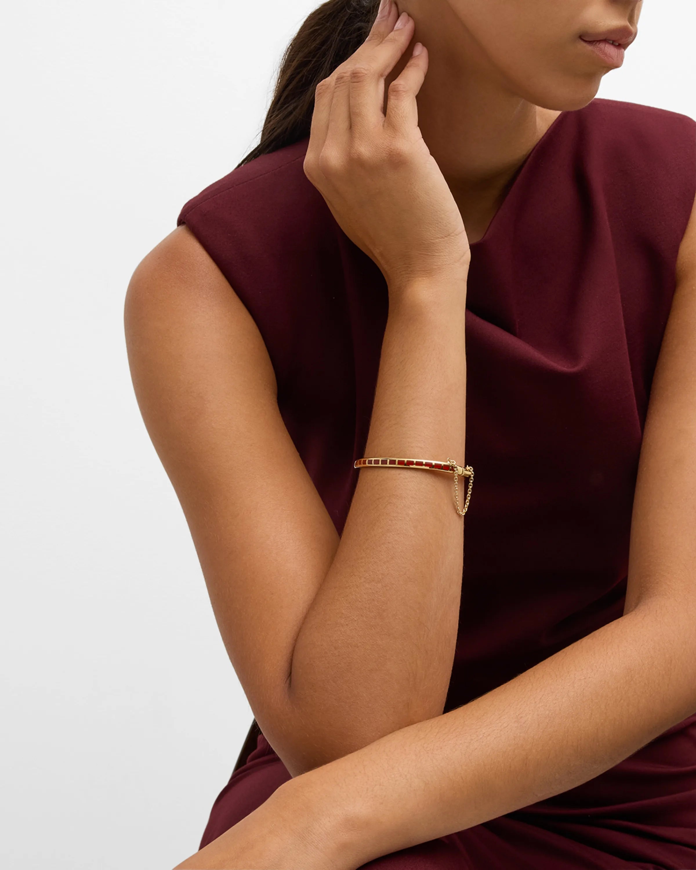 Channel-set coral red square tile gold vermeil open cuff bangle bracelet worn on model's wrist