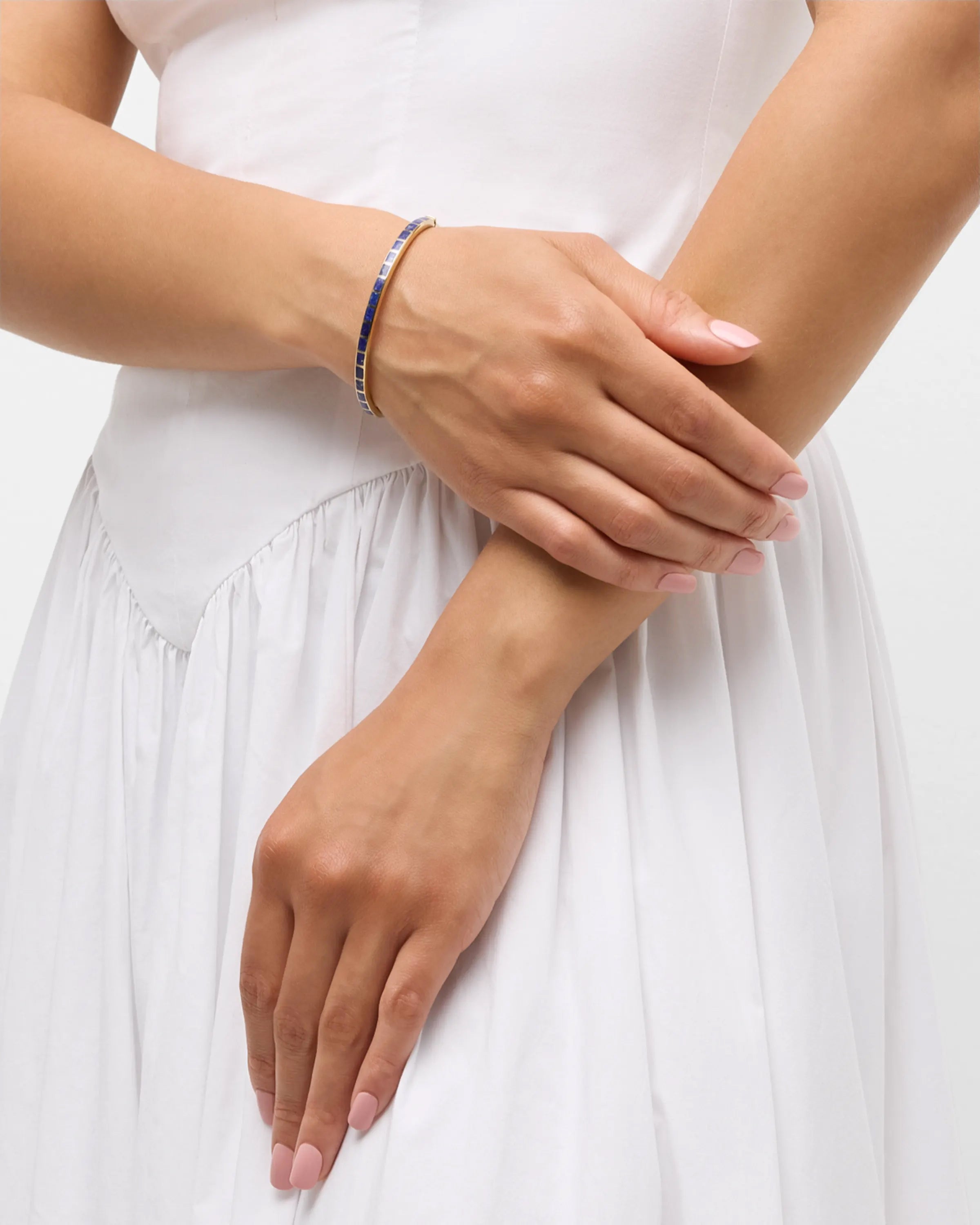 channel-set lapis lazuli square tile gold vermeil open cuff bangle bracelet worn on model's wrist