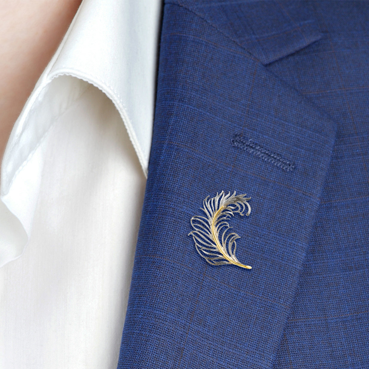 Two-tone sterling silver and gold open-work feather lapel pin — a striking, artisan-crafted accessory that adds a touch of refined elegance to any suit or blazer.