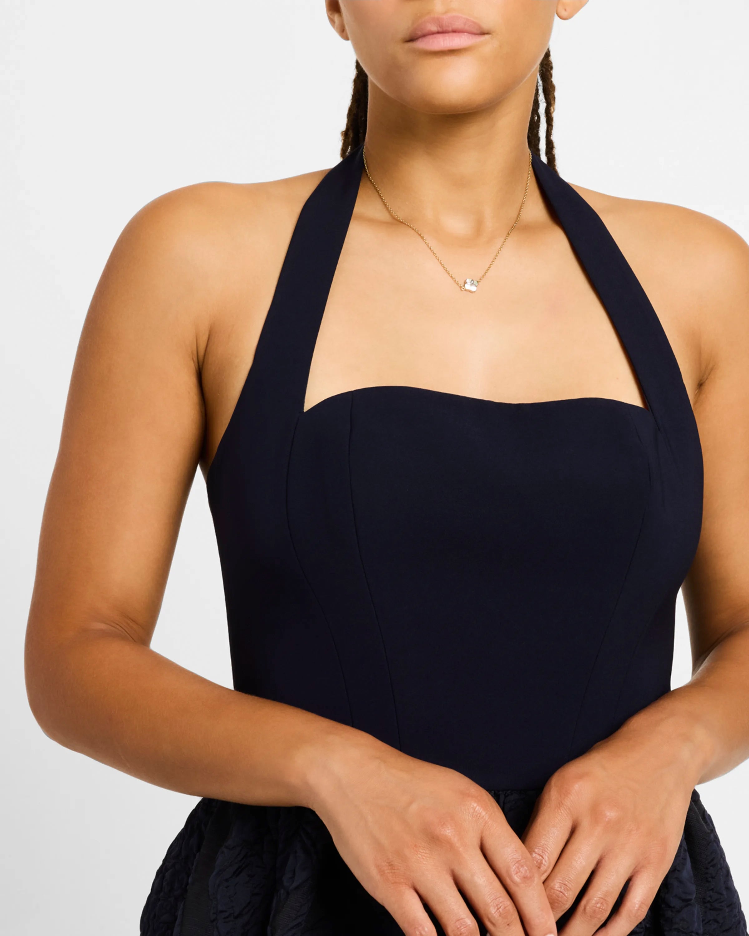 Model in black halter dress wearing white mother-of-pearl quatrefoil gold pendant necklace — Jan Leslie