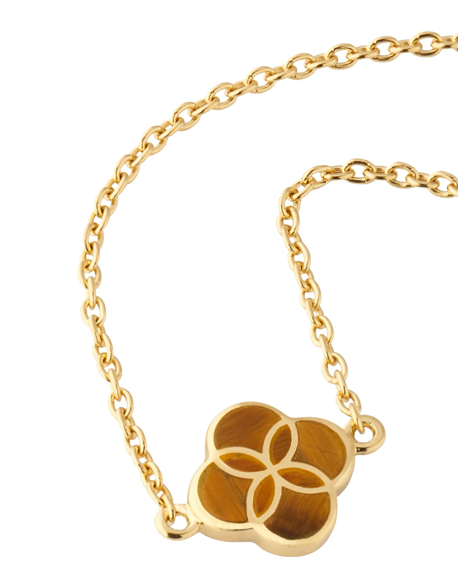 Close-up of tiger's eye quatrefoil inlay gold pendant necklace on rolo chain — Jan Leslie
