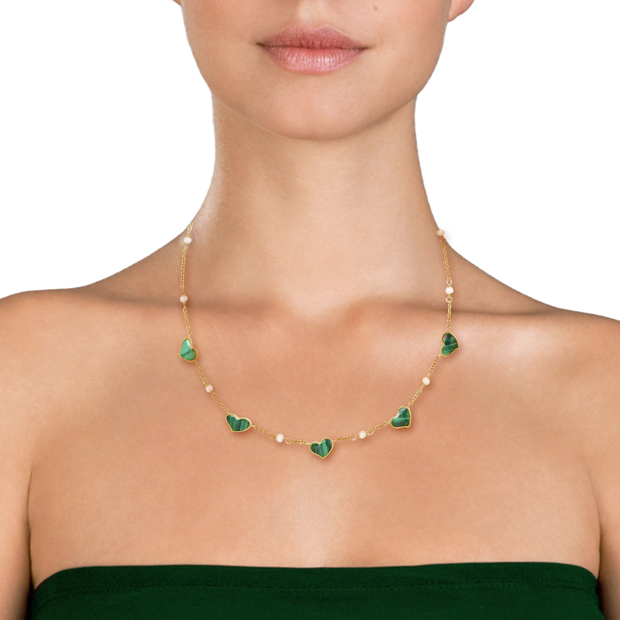 Woman wearing gold vermeil malachite heart and freshwater pearl station necklace at collarbone length over green strapless dress, Jan Leslie luxury women's fine jewelry lifestyle.