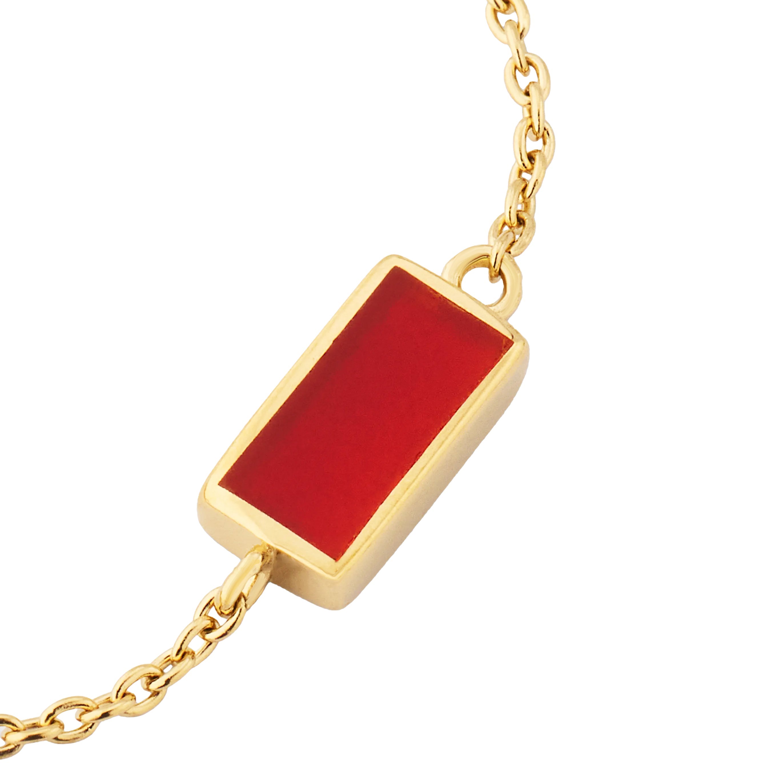 Close-up of carnelian bar pendant in gold bezel setting showing vivid red stone by Jan Leslie.