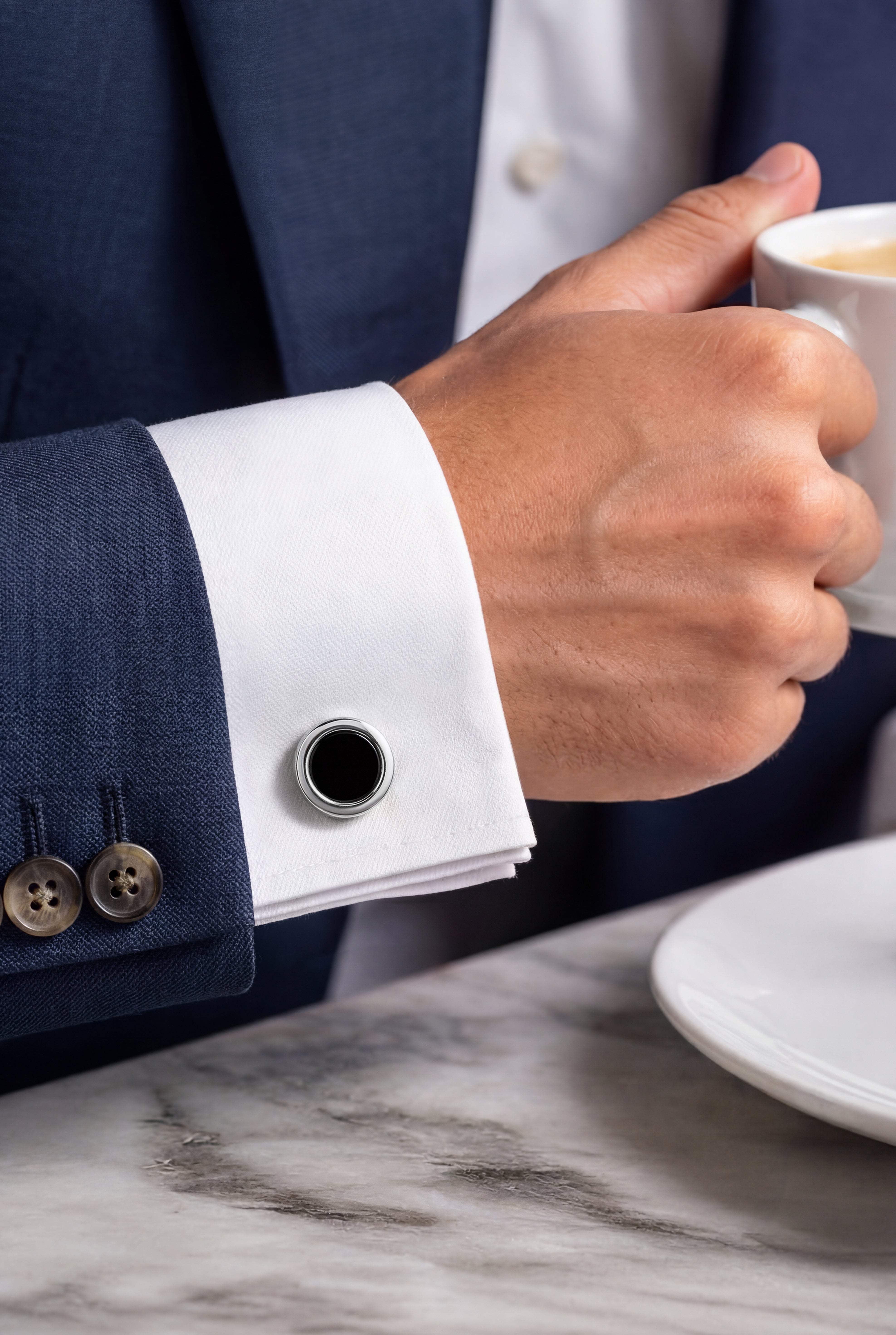 Sterling silver round mother-of-pearl cufflinks worn on white French cuff, Jan Leslie
