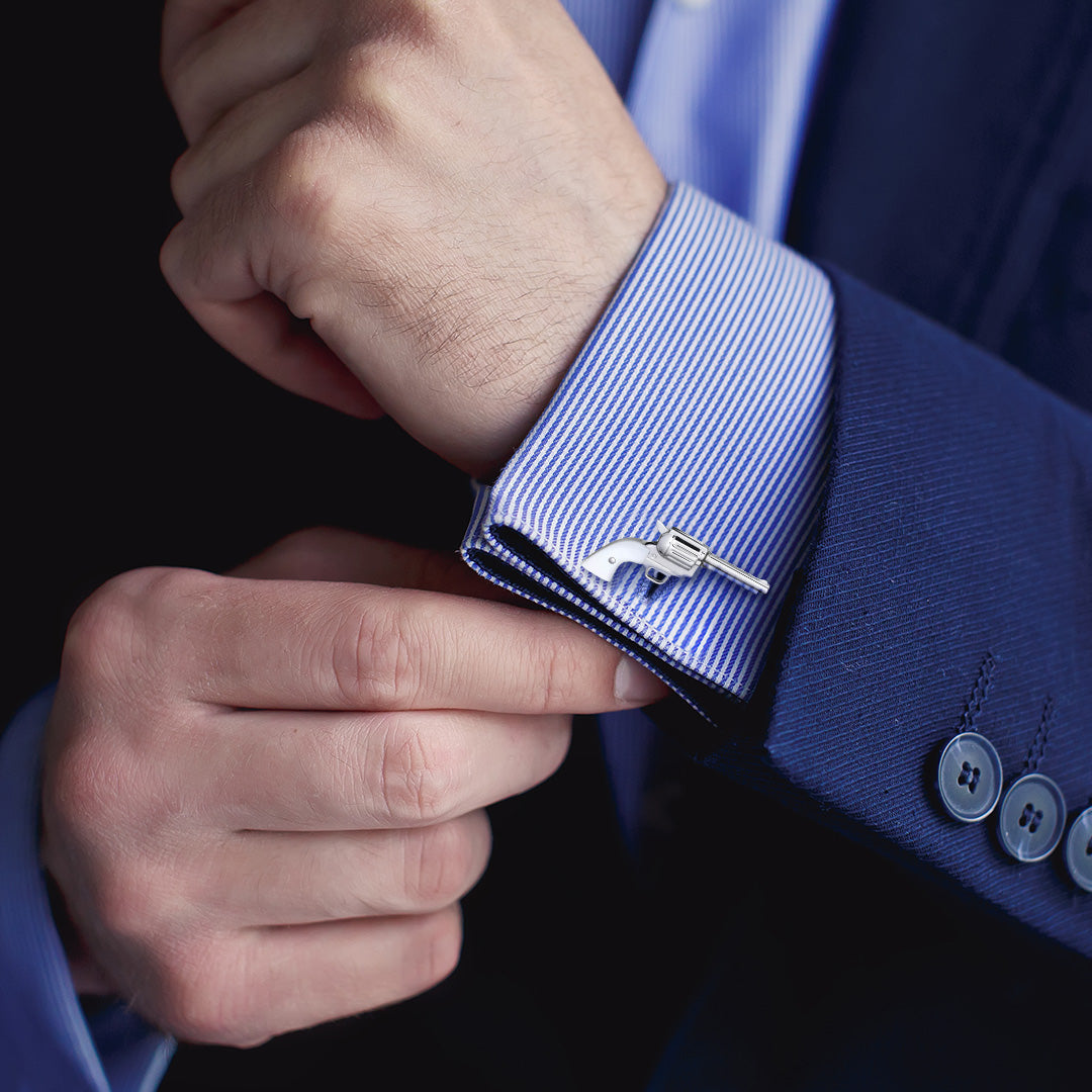 Close up of male models wrist donning the Pistol with Bullet Back Mother of Pearl Sterling Silver Cufflinks 