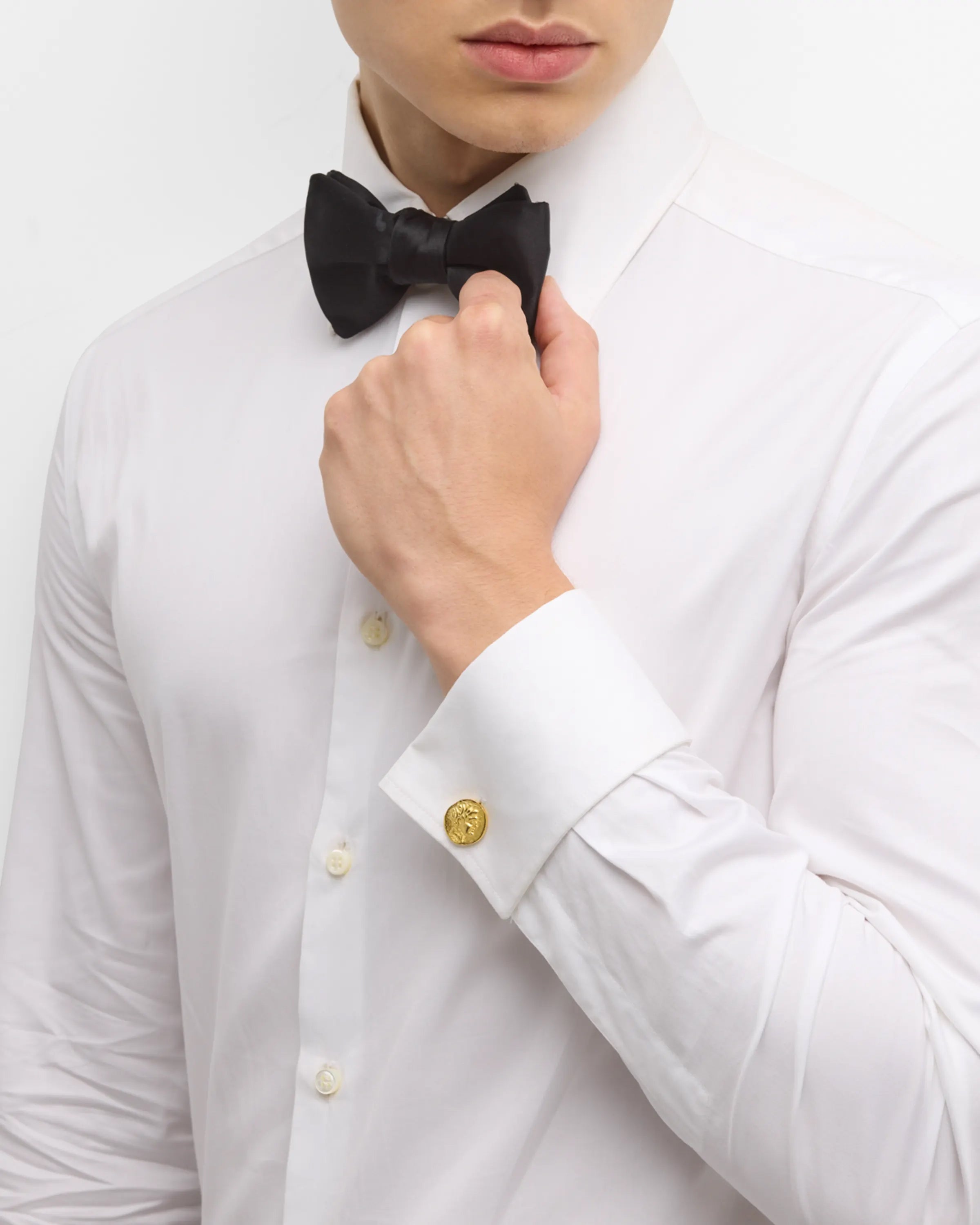 Men's gold ancient coin cufflinks styled on white tuxedo shirt with black bow tie, Jan Leslie