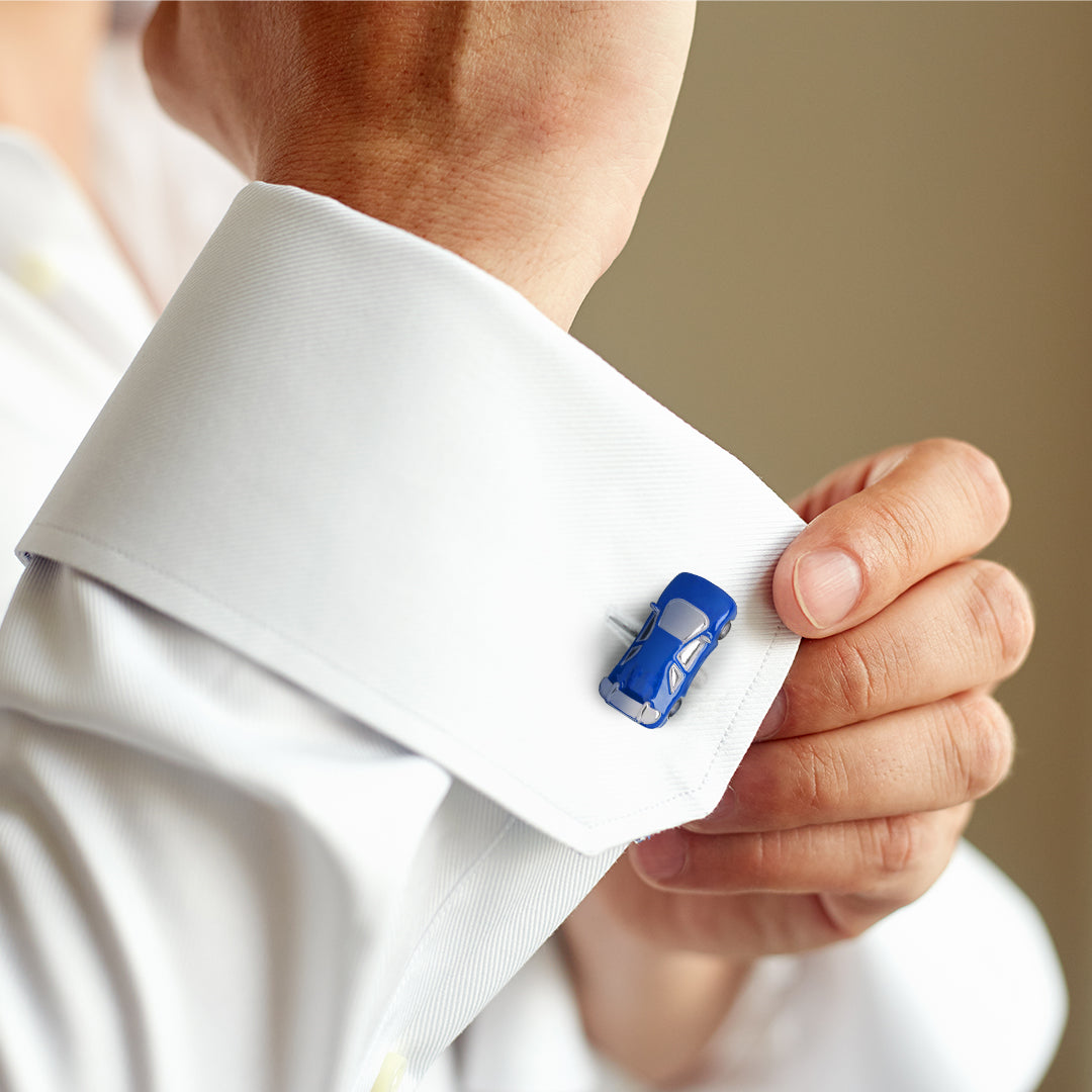 Man adjusting white French cuff dress shirt wearing sterling silver and cobalt blue enamel sports car cufflink on cuff, Jan Leslie