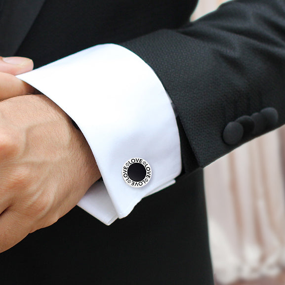 Man wearing sterling silver black onyx LOVE round cufflink on white French cuff with black tuxedo jacket by Jan Leslie